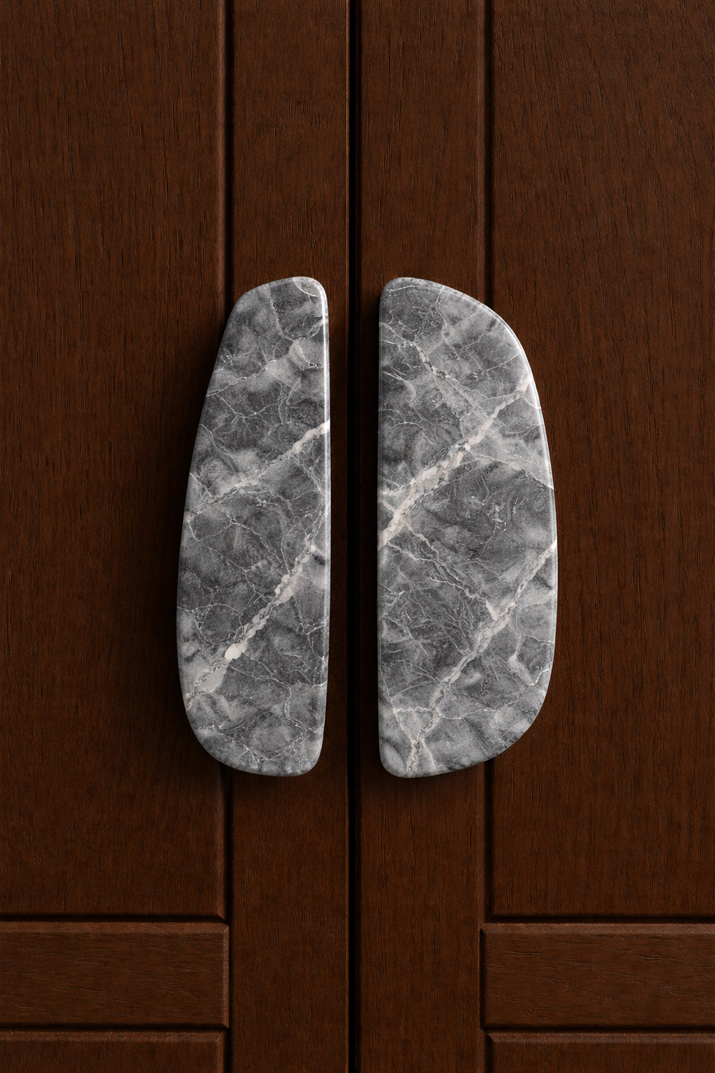 Close-up of marble door handles on wooden door.