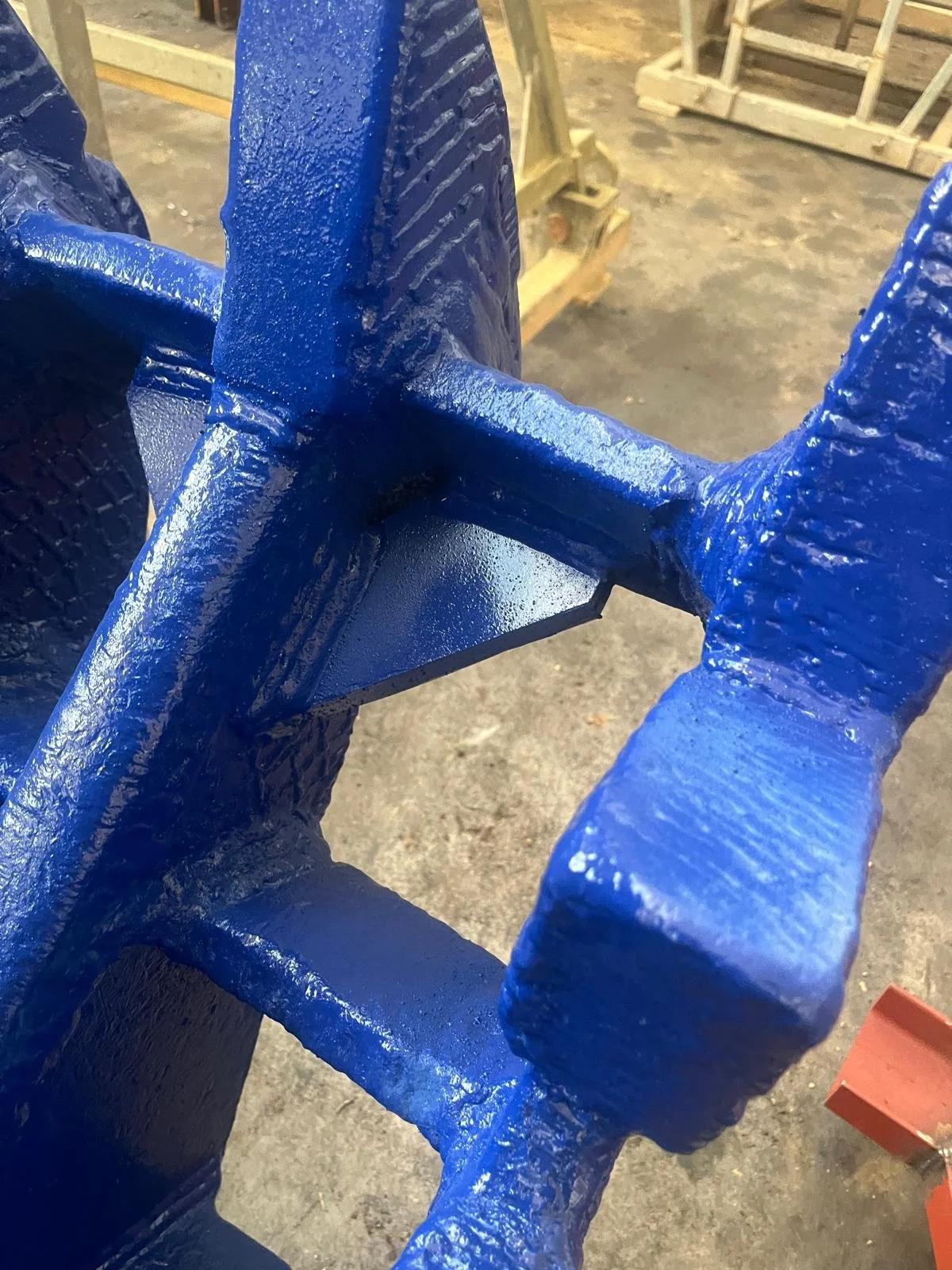 Estructura de metal pintada de azul en un taller o área de fabricación.