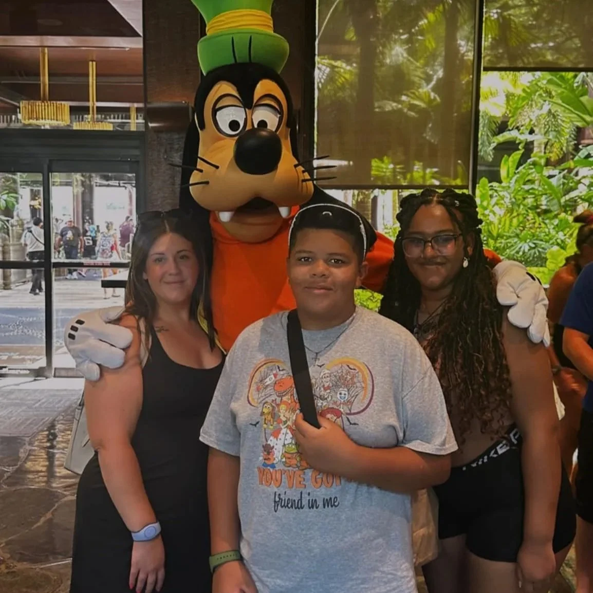 Winnie Lane & Co. founder and family posing with Goofy during a vacation.
