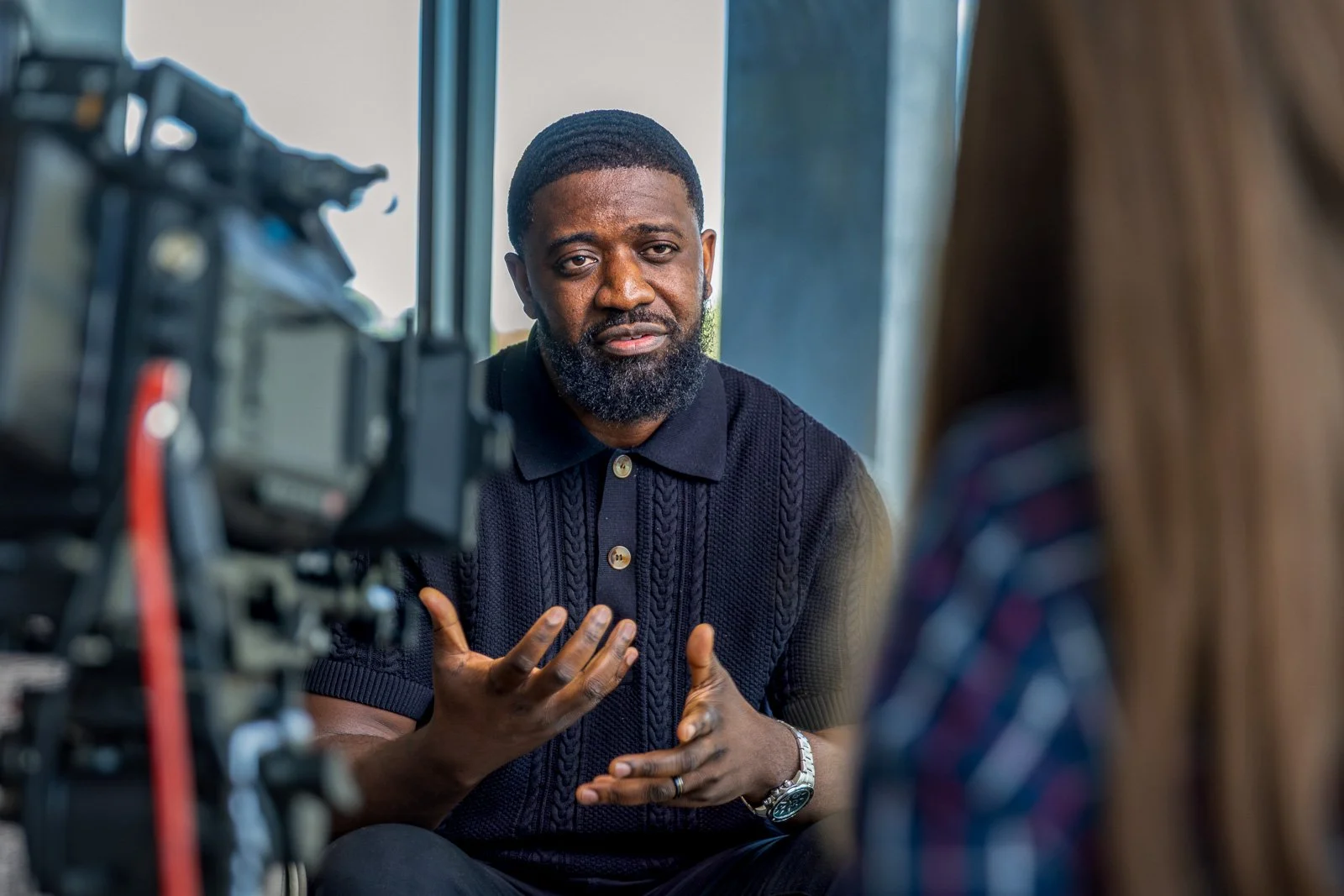 Man is being interviewed about his experience in a refugee camp in Kenya.