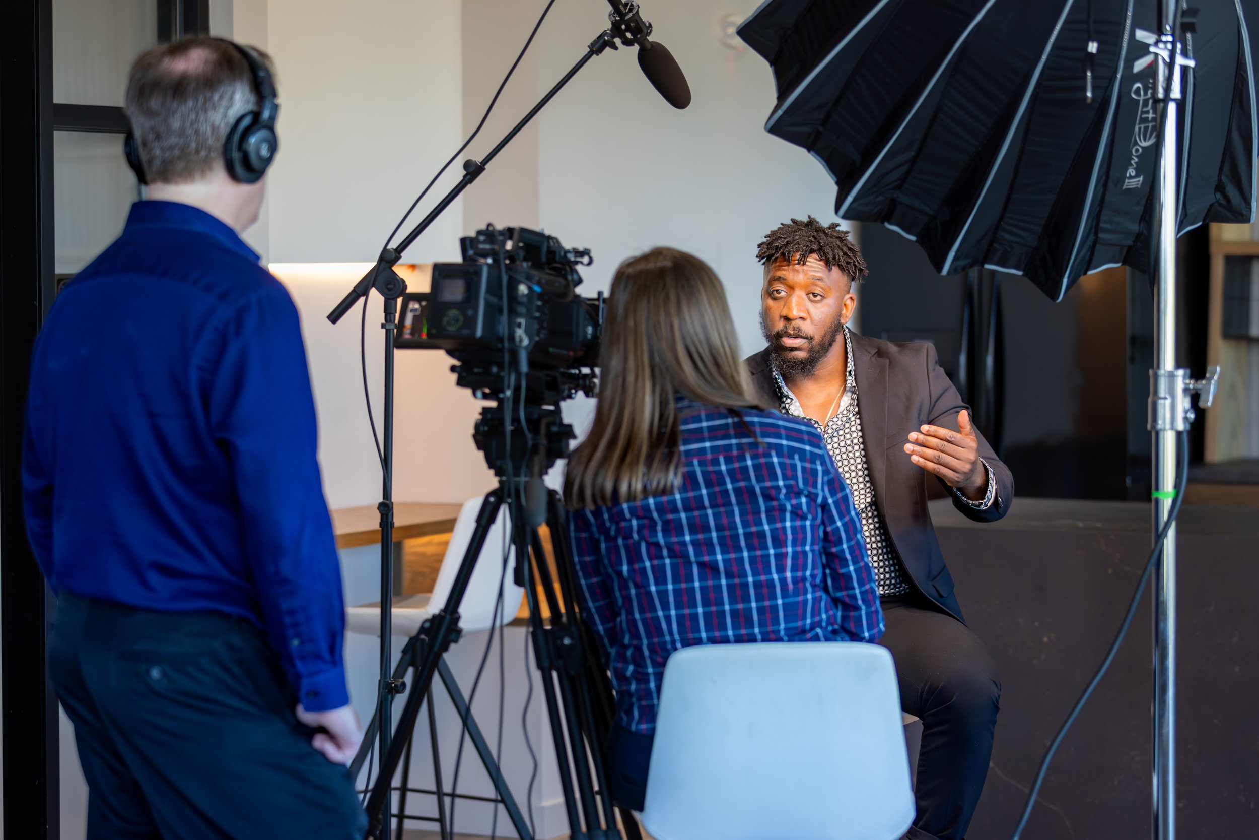 camera operator and producer with person on-camera talking