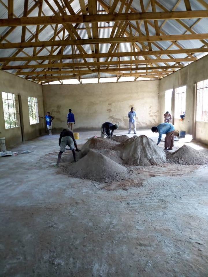 Loading in material for the floor in dining hall.