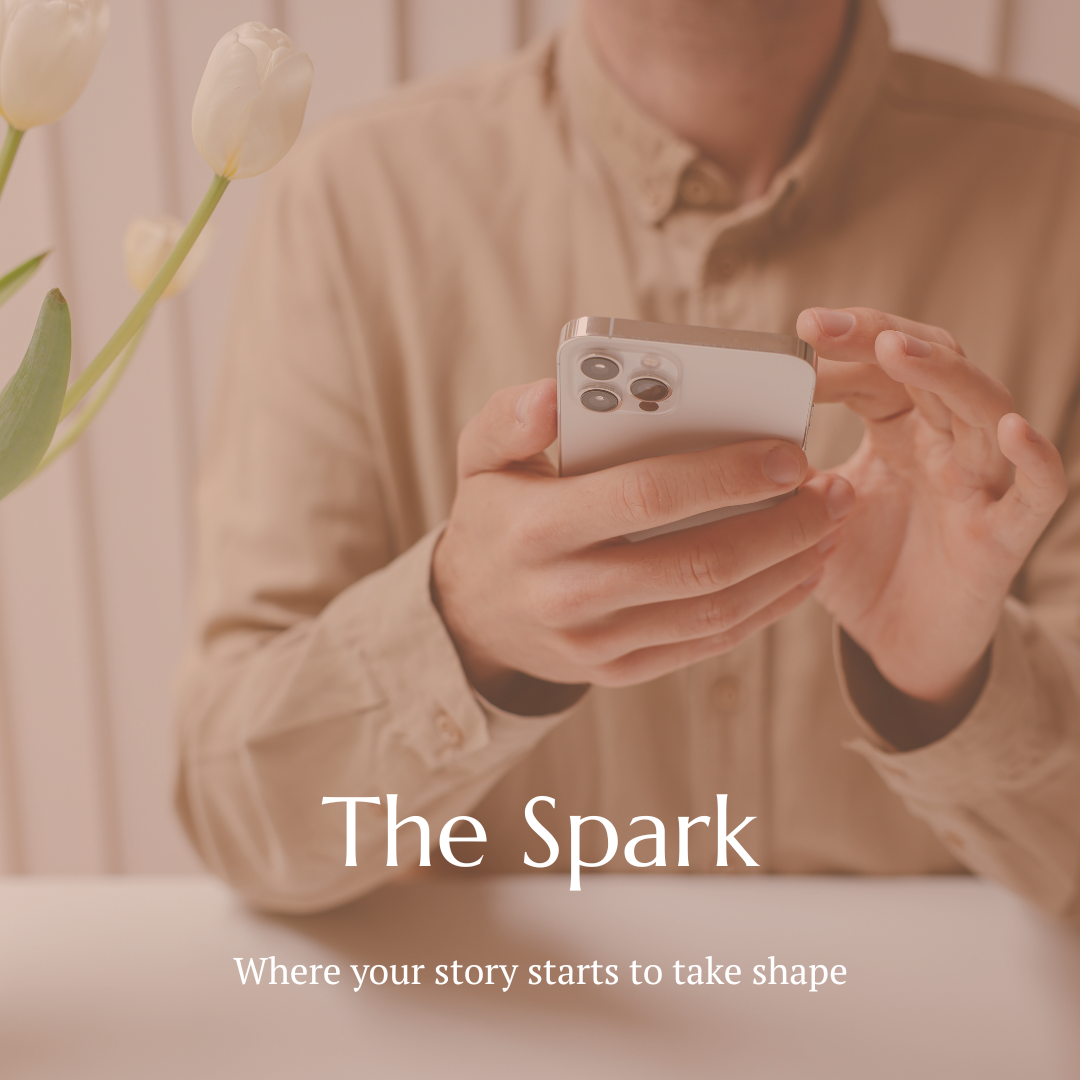 A person holding a smartphone, with white tulips on the left side of the frame. Text overlay reads "The Spark: Where your story starts to take shape."