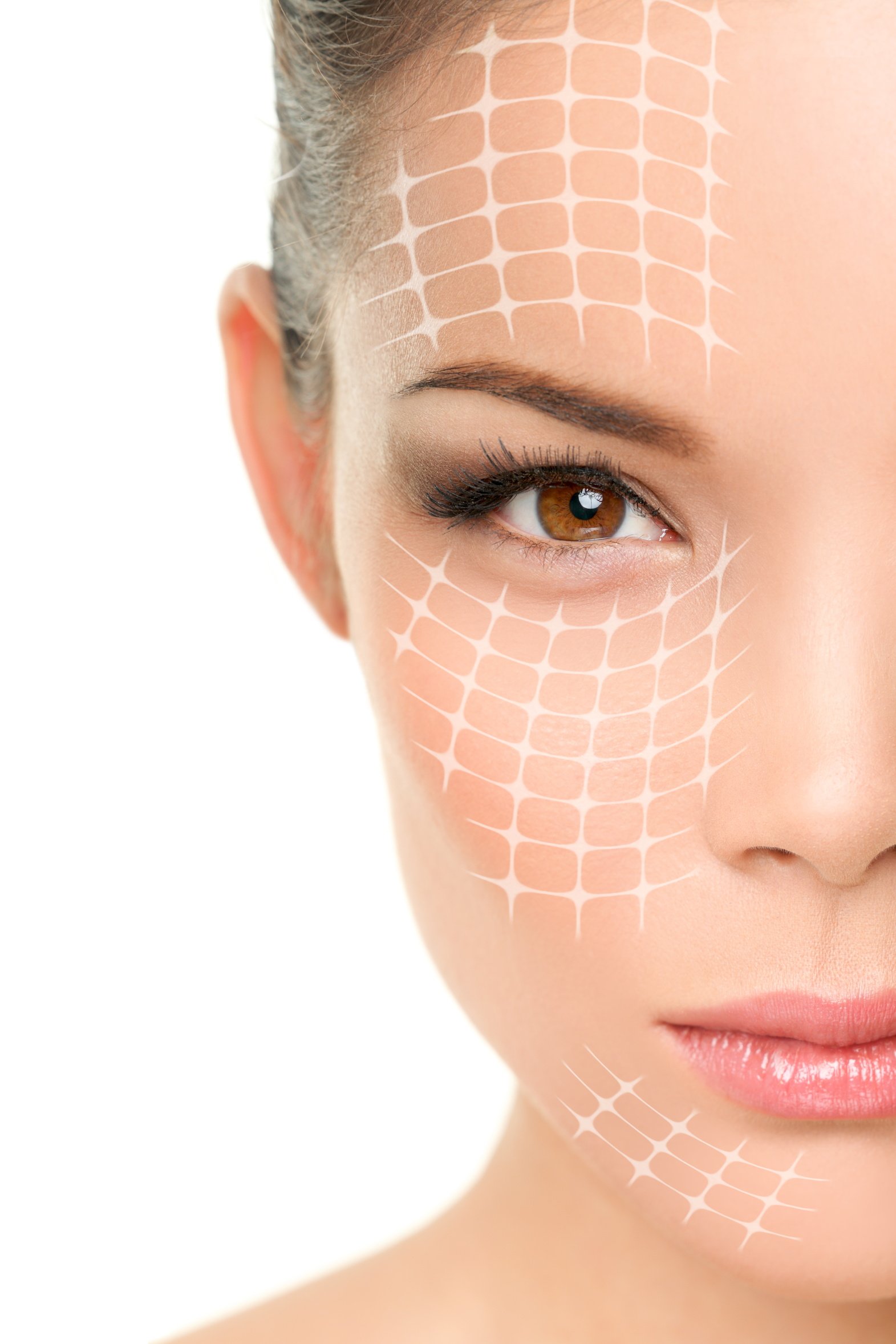 Close-up of a woman's face with a honeycomb-patterned mark on her forehead, cheek, and chin, and eye makeup.