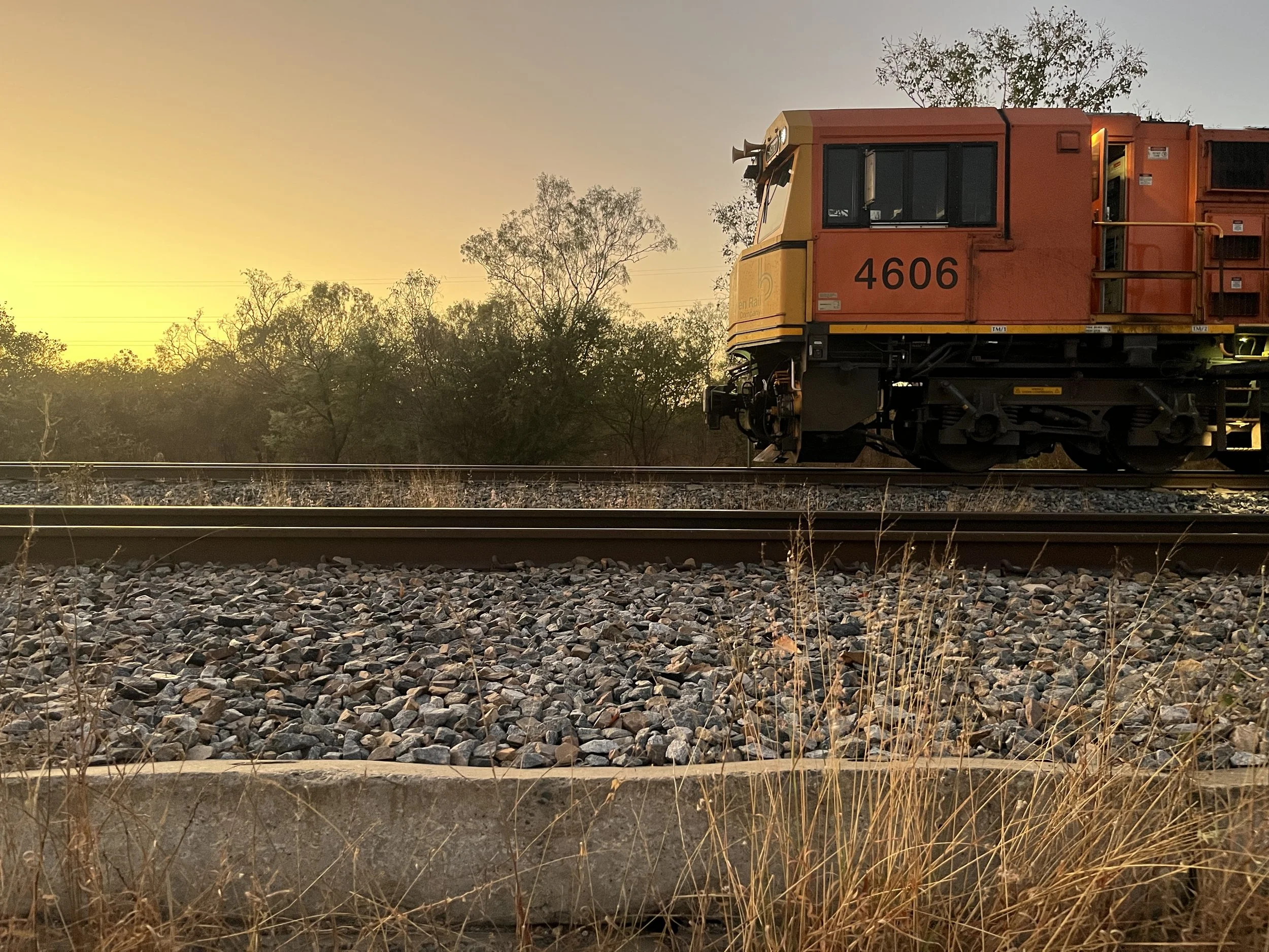 An orange train car on a railway track during sunset, Copyright of Stephanie Munns Heilsa Consulting Pty Ltd