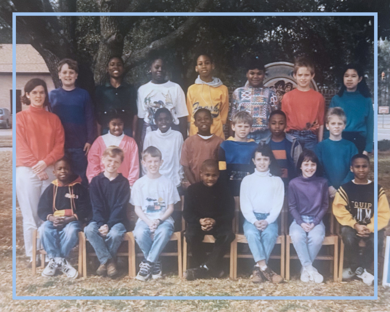 Caroline as a school teacher standing with former students for a class photo in the 1990s.