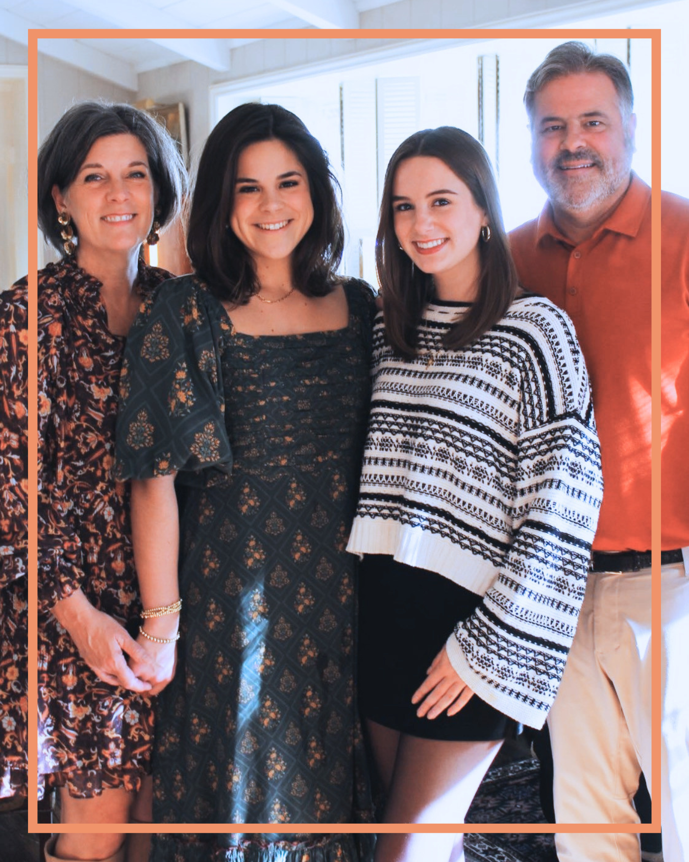 Caroline stands with her two daughters and husband.