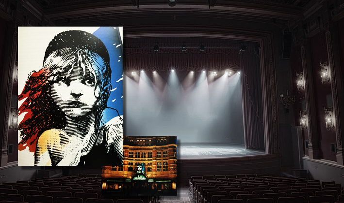 empty but lit up stage with a poster of les miserables