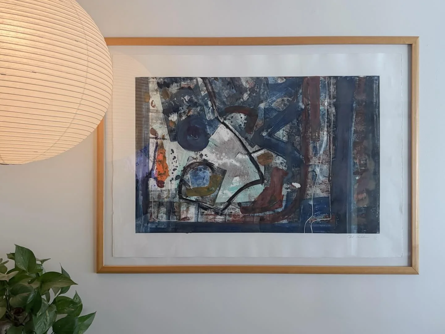 AVAILABLE &mdash; $150

Signed abstract monoprint &mdash; Mixed Media on Paper

Large-scale abstract print in a natural wood float frame. The work layers gestural brushwork, splatter, and painterly marks across a deep navy and slate ground, with hits