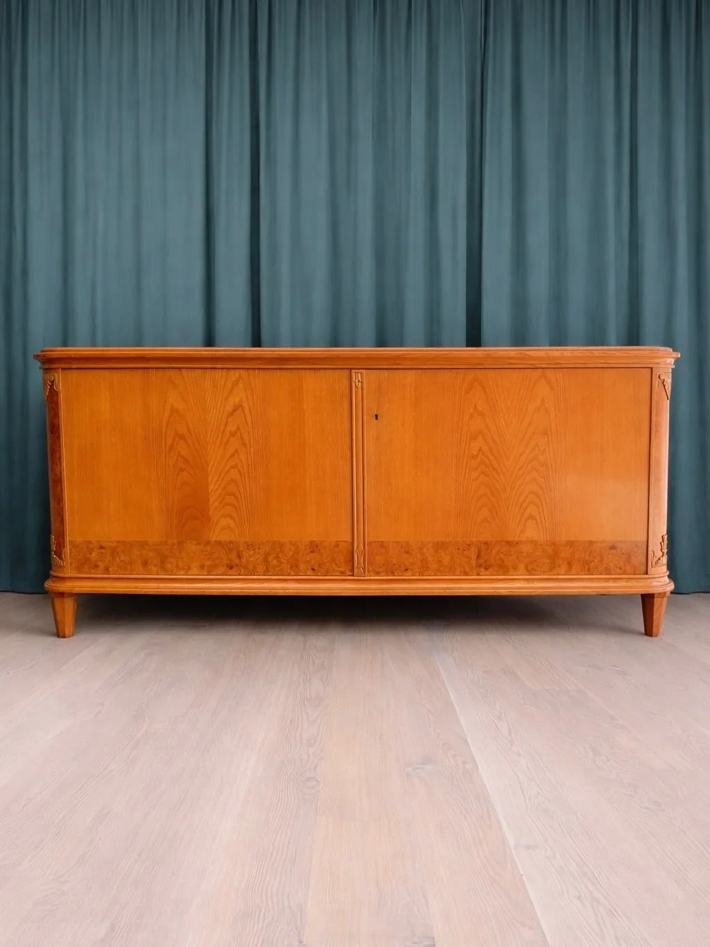 *AVAILABLE* &mdash; $800
Swedish Elm &amp; Birch Burlwood Sideboard, circa 1950s.
Sits at the intersection of Nordic modernism and Art Deco &mdash; clean proportions with ornate carved corner details and a burlwood veneer band along the base of the d