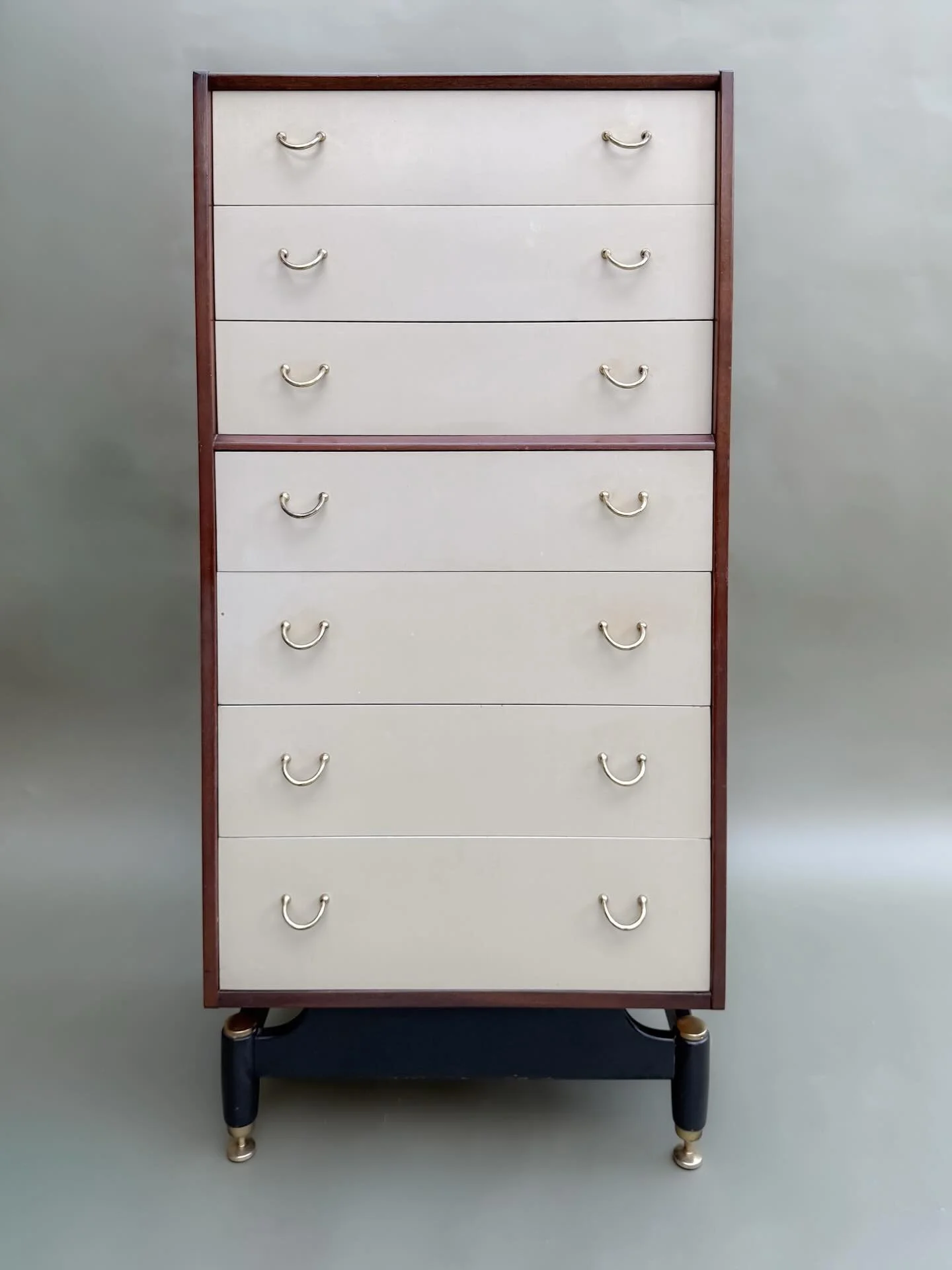*AVAILABLE* $1,100

G-Plan Tola Tallboy Chest of Drawers &mdash; Tola Wood &amp; Cream Lacquer, circa 1960s

Seven-drawer tallboy from G-Plan&rsquo;s Tola range, made in Great Britain circa 1960s. Tola wood carcass with cream lacquered drawer fronts 