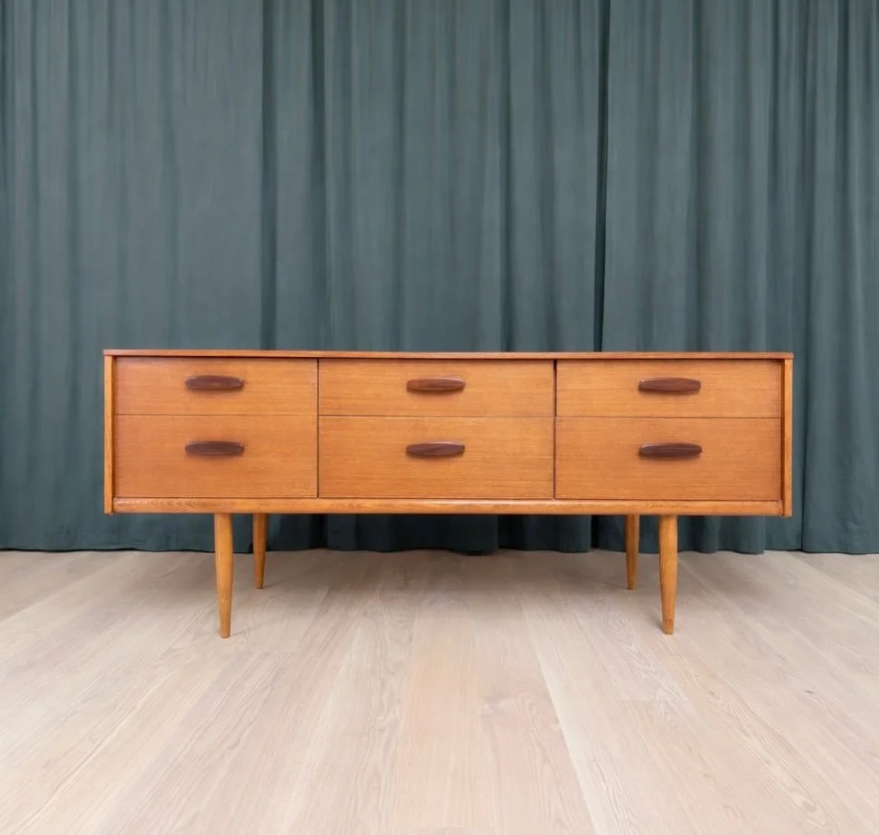 *SOLD* 

1960s British Teak Six-Drawer Dresser - Tapered Oak Legs &amp; Sculpted Oval Pulls

Excellent vintage condition! Well-built solid teak credenza by British maker, Austinsuite, circa early 1960s. The case holds six drawers arranged in 3 equal 