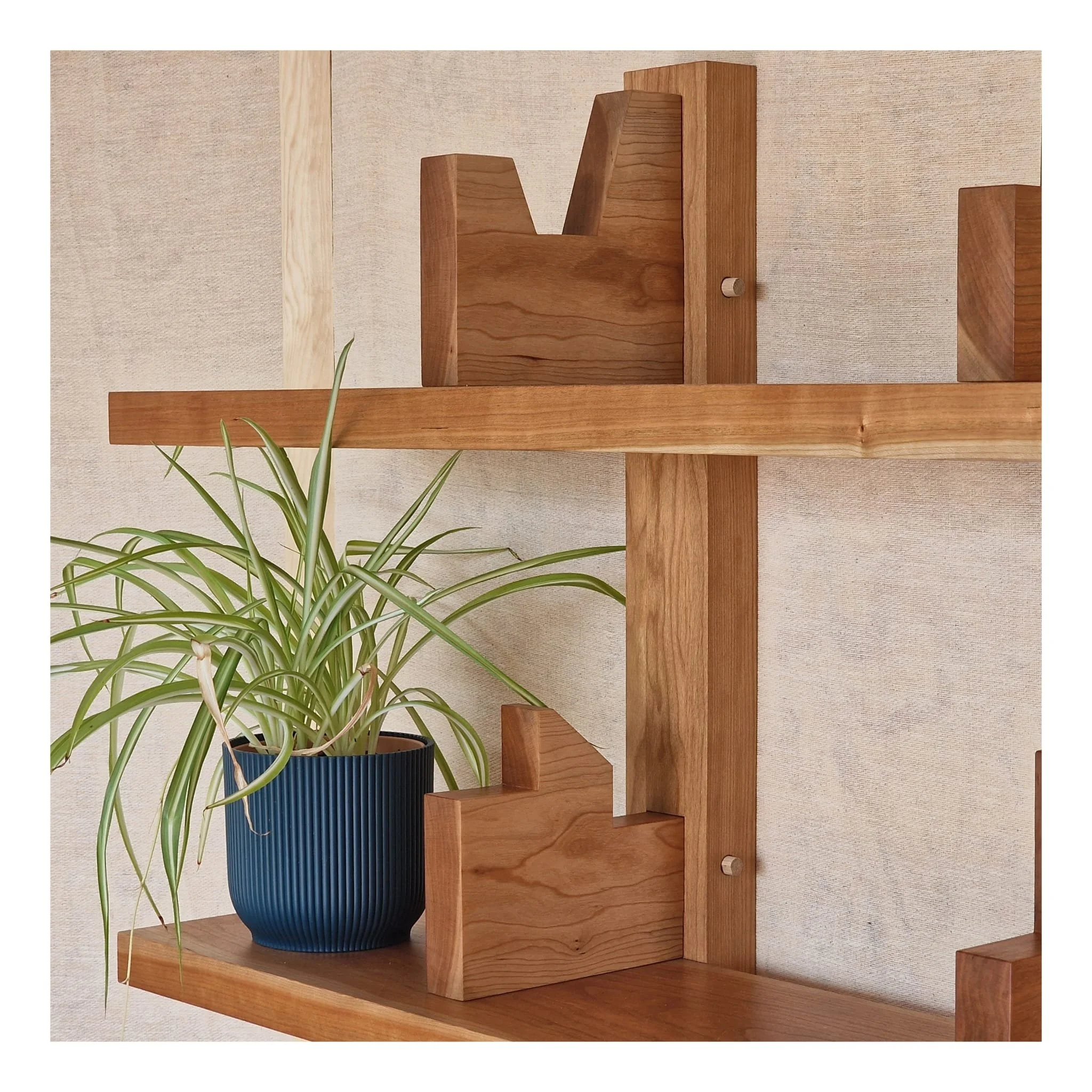 A solid cherry bookcase inspired by profiles seen in Brutalism architecture... 