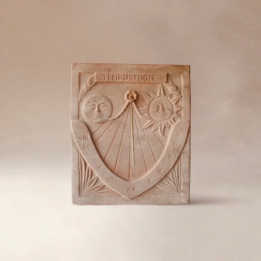 Engraved sundial with sun and moon faces, Roman numerals, and the words 'Tempus Fugit' at the top.