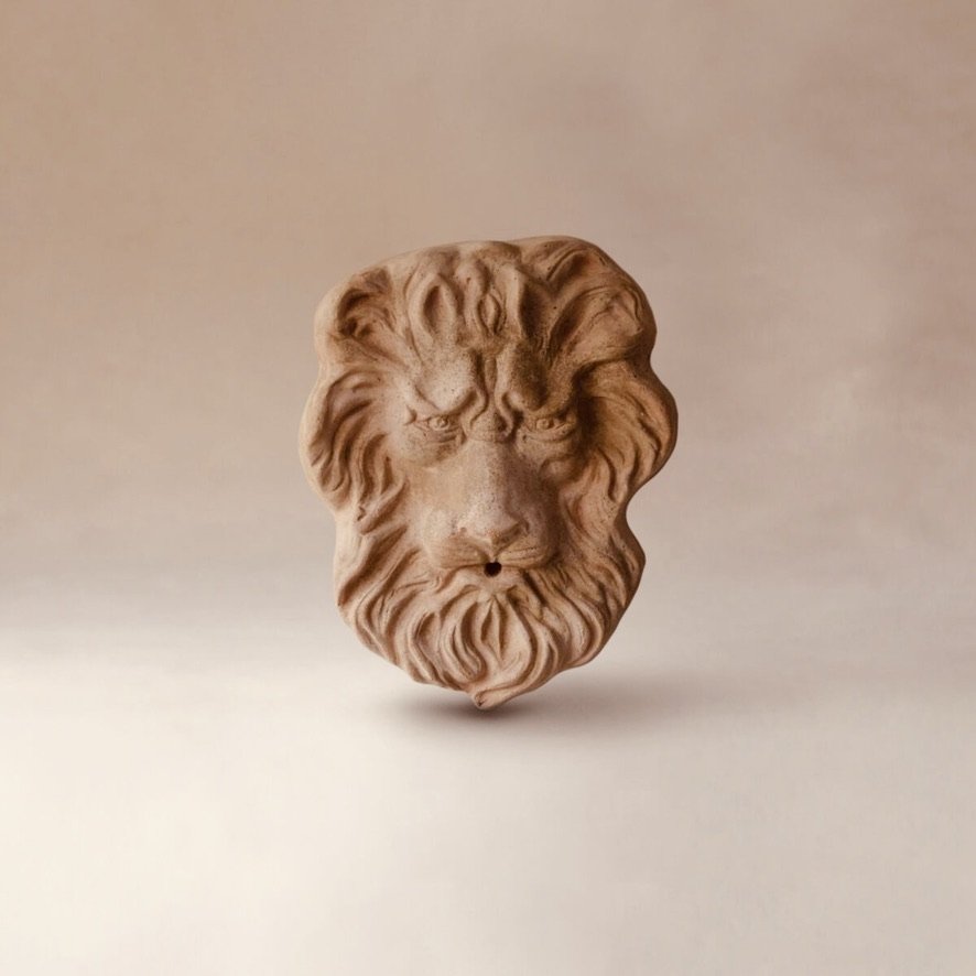Sculpted lion's head made of clay or similar material