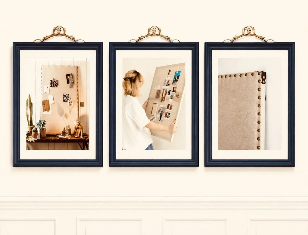 A woman looking at a photo display board in an art gallery, with two other framed pictures on the wall above a white wainscot.