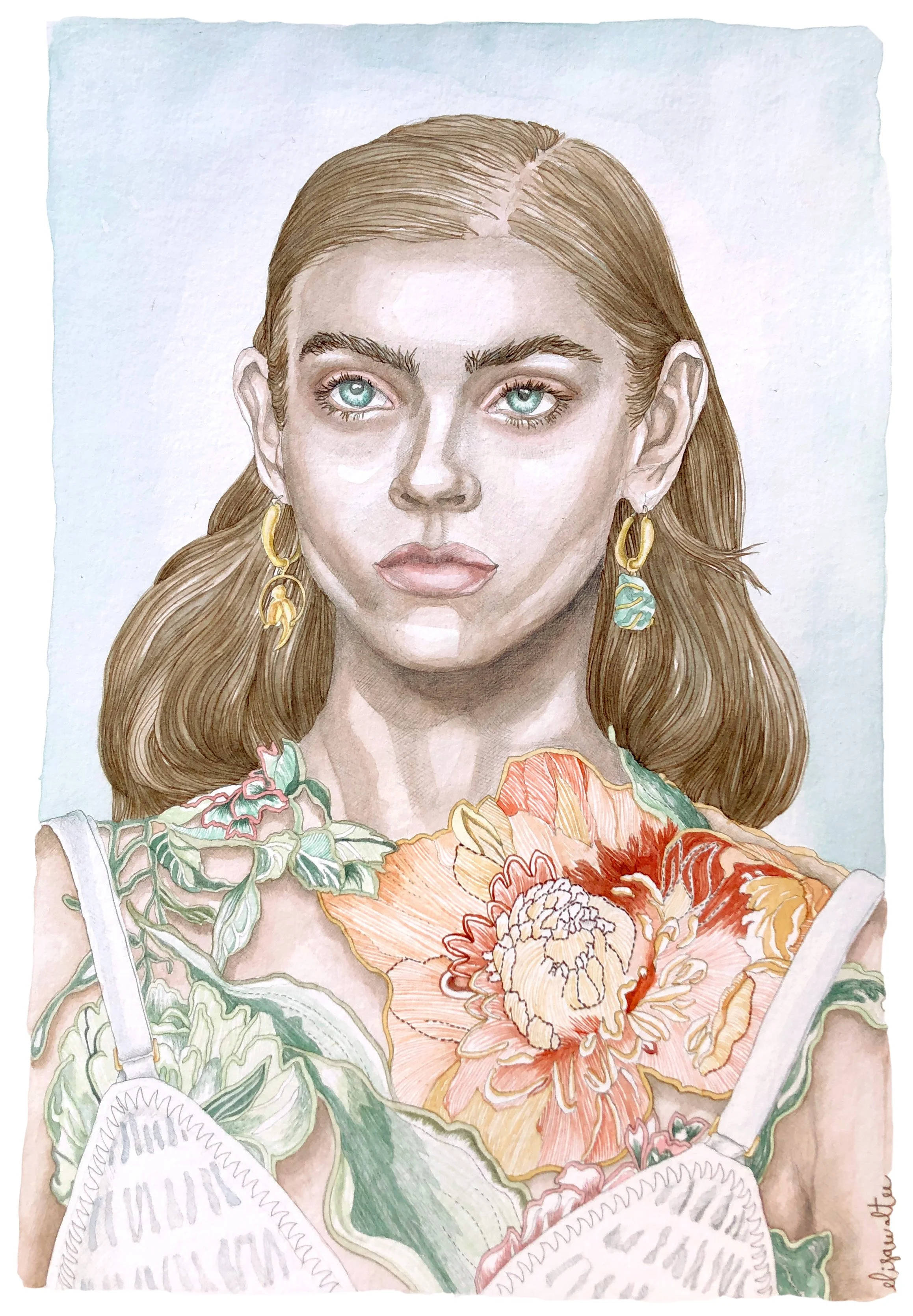 Portrait of a young woman with brown hair, wearing gold earrings adorned with turquoise stones, dressed in a colourful floral patterned dress.