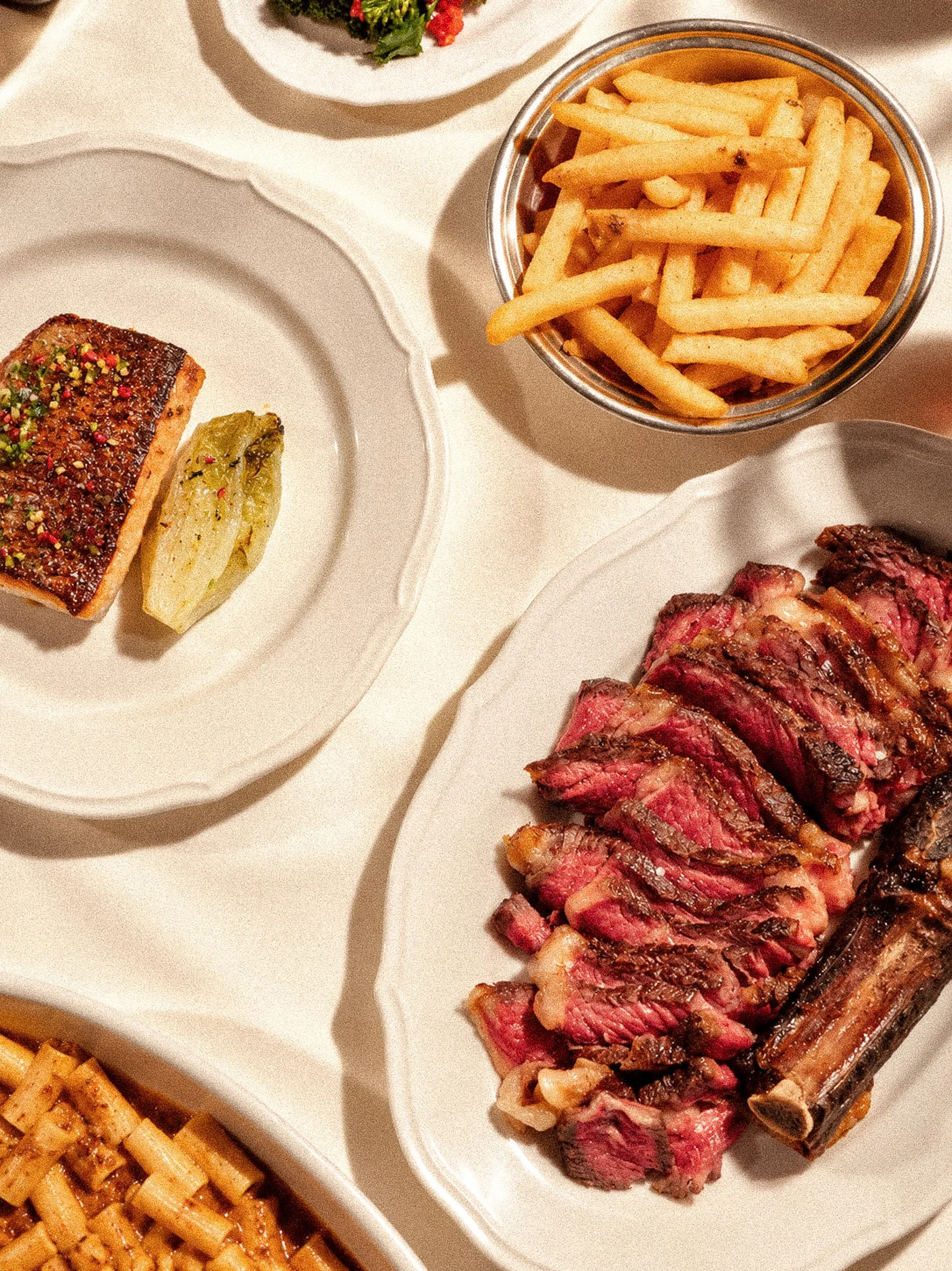 Sunlit Bistro Feast with Steak and Fries.jpg