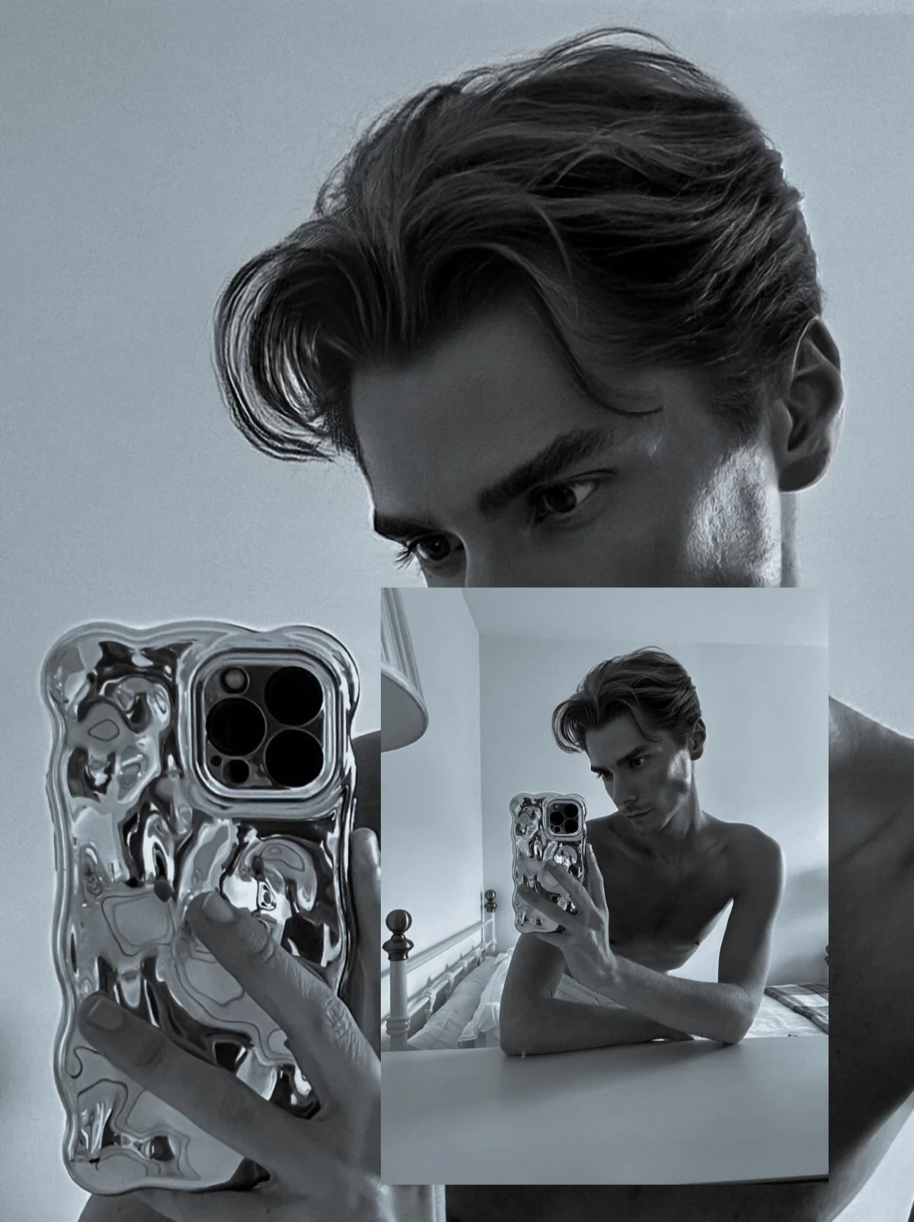 Black and white photo of a young man taking a mirror selfie with his phone, showing a reflection of his face and upper body, with close-up detail on his hair, face, and reflective phone case.
