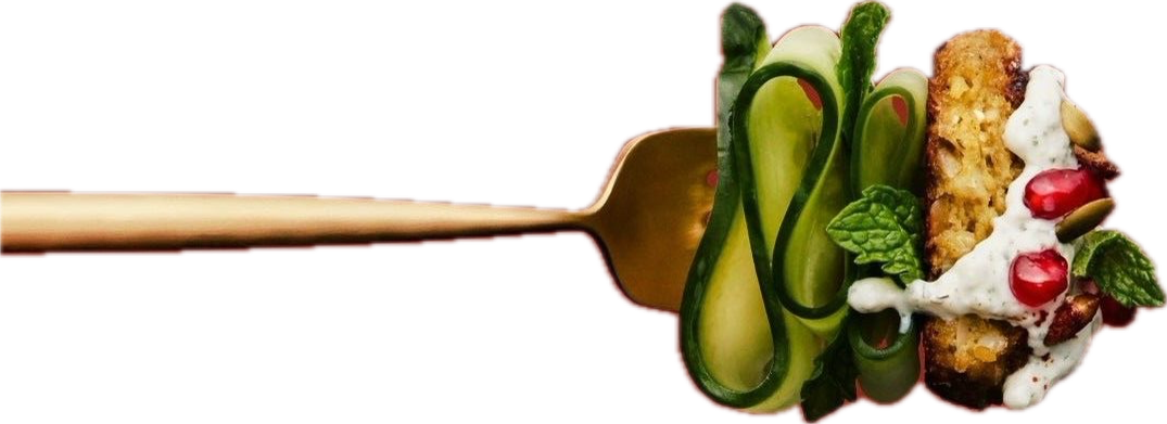 A skewer with a vegetable and meat dish, including cucumber curls, herbs, and a meat patty with sauce and garnishes.