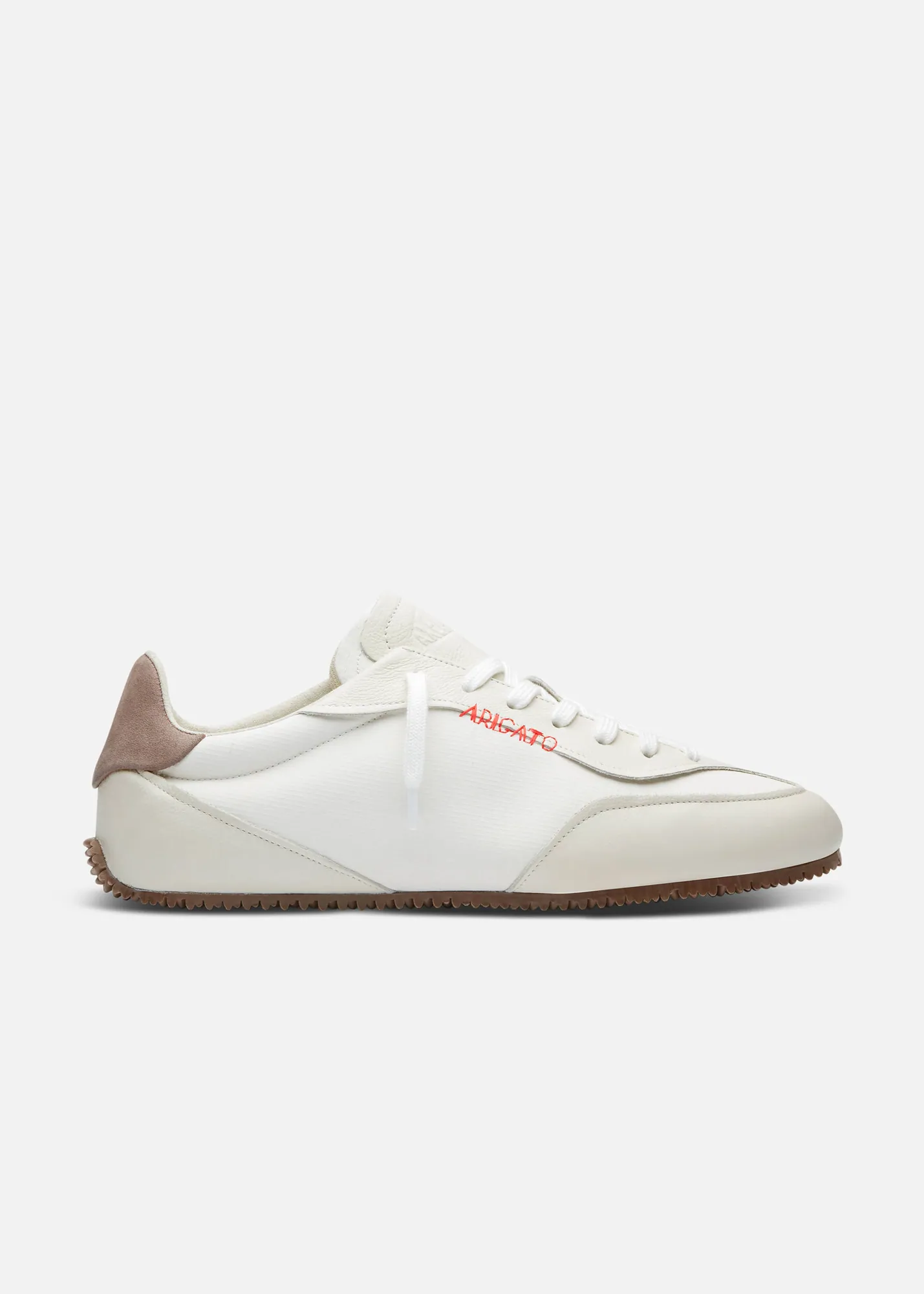 White sneaker with beige heel tab and red embroidered text on the side, against a plain white background.
