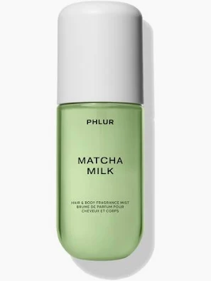 A light green cylindrical bottle with a white cap labeled 'PHLUR MATCHA MILK HAIR & BODY FRAGRANCE MIST'.