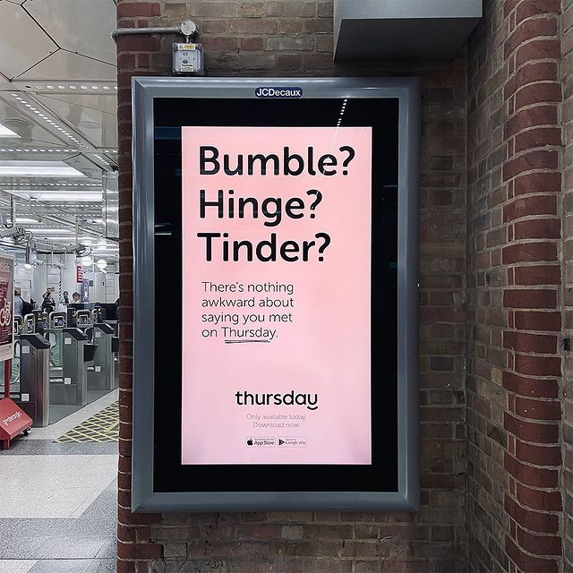 Digital advertisement at a subway station with pink background and black text highlighting questions about dating apps and services, mentioning Thursday and encouraging app download.