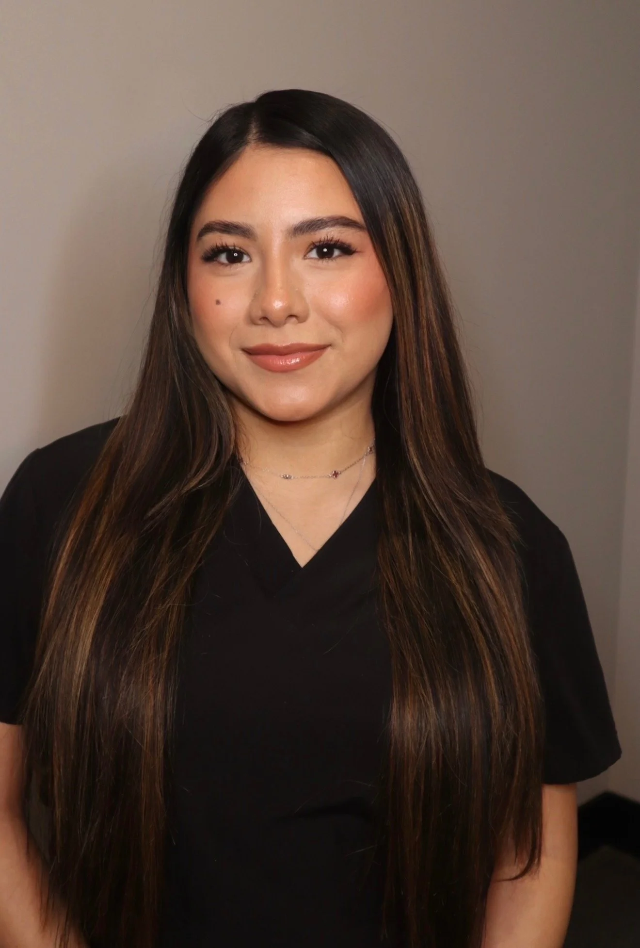 A woman with black hair wearing a black shirt