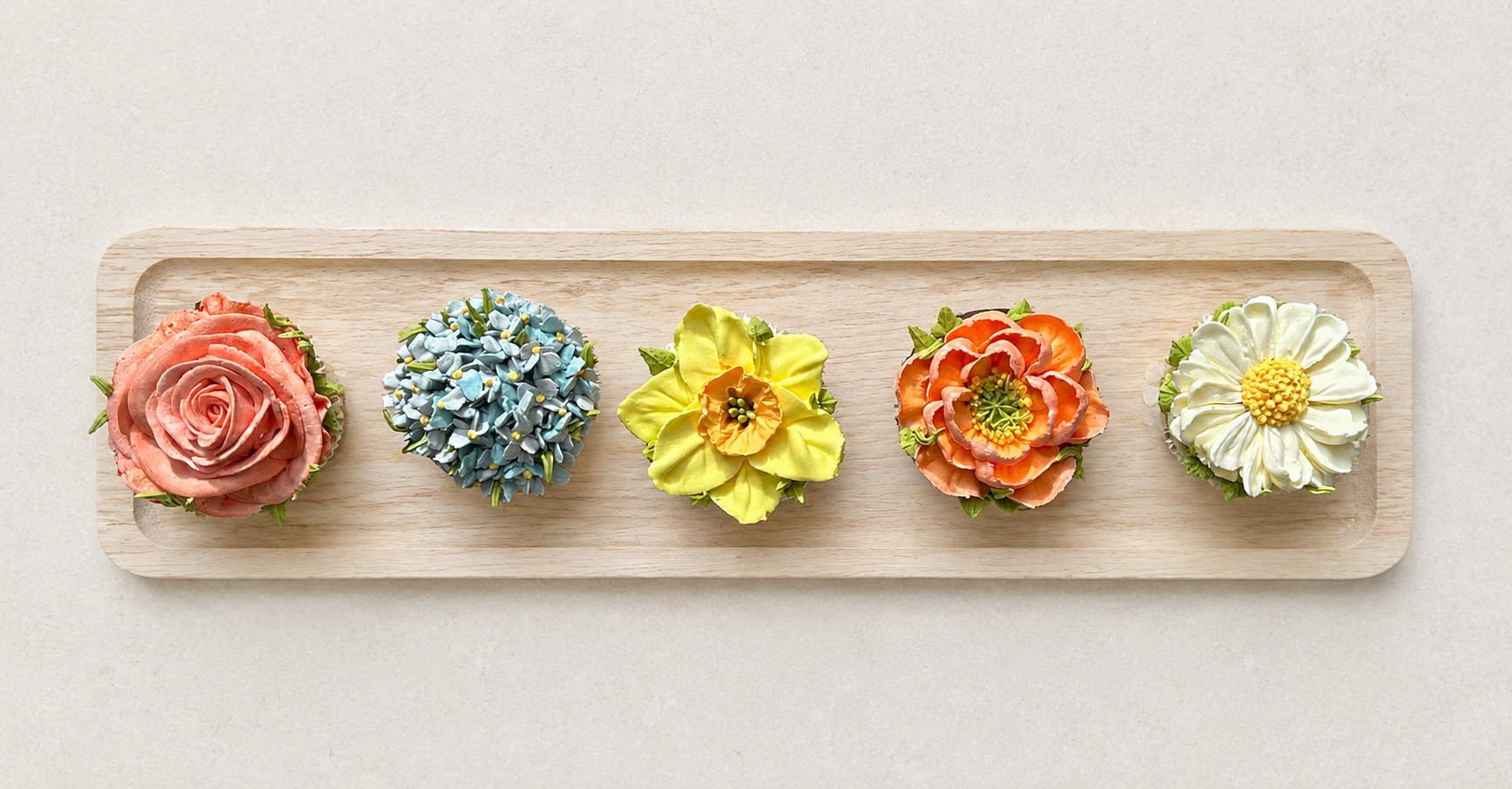 Hand-piped rose, hydrangea, daffodil, daisy and poppy cupcakes, handcrafted in Dublin by Full Bloom Bakehouse. A luxury floral cupcake collection featuring realistic buttercream flowers, perfect for birthdays, gifting, spring celebrations and special