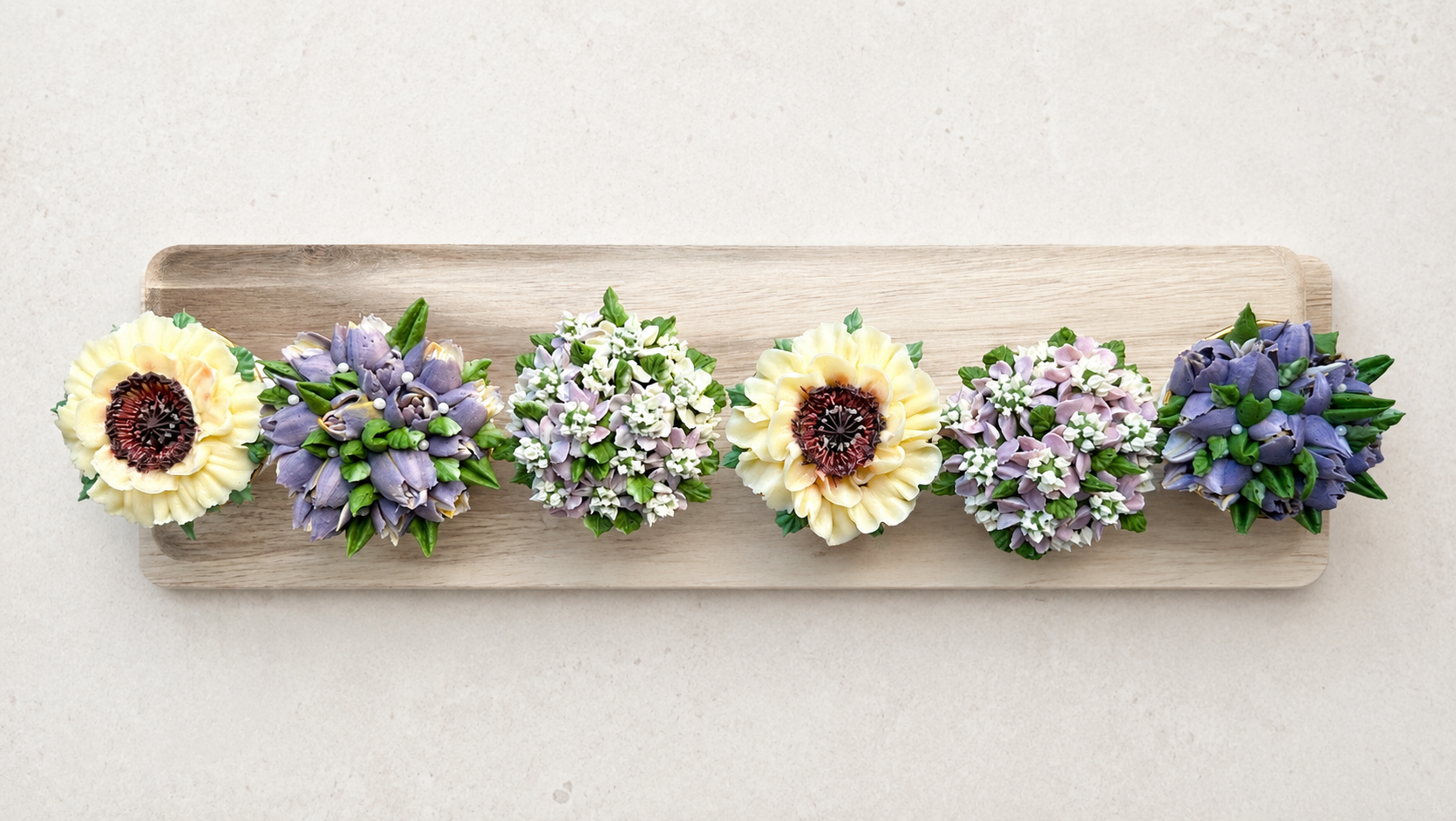 Hand-piped white and lilac floral cupcakes, handcrafted in Dublin by Full Bloom Bakehouse. Elegant buttercream flower cupcakes perfect for weddings, engagements, birthdays, Mother's Day and special celebrations. Luxury floral cupcakes available to or