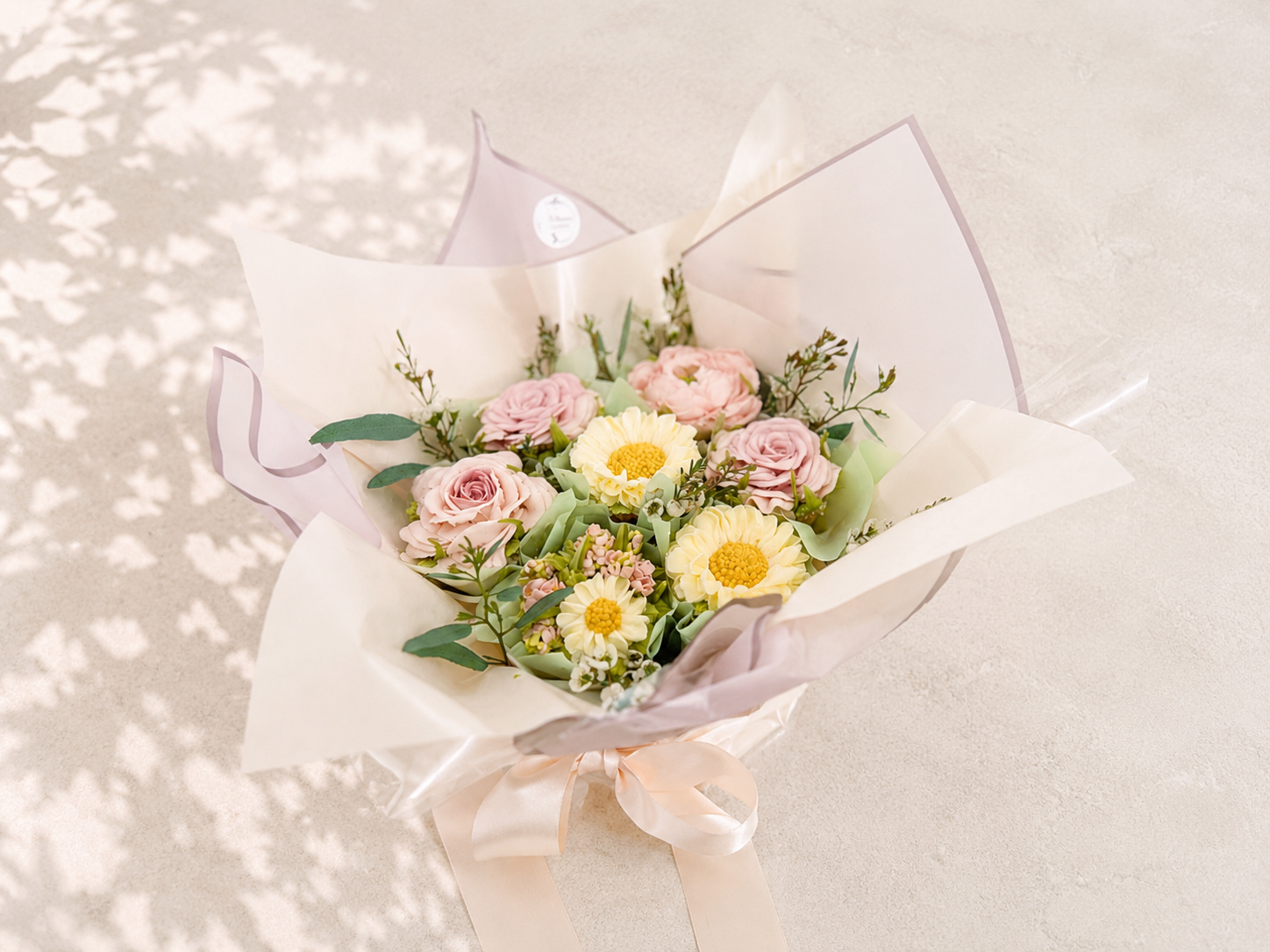 Seven-cupcake bouquet featuring hand-piped roses and daisies with fresh eucalyptus, handcrafted in Dublin by Full Bloom Bakehouse. A luxury floral cupcake bouquet inspired by fresh garden flowers, perfect for birthdays, Mother’s Day, thank you gifts,