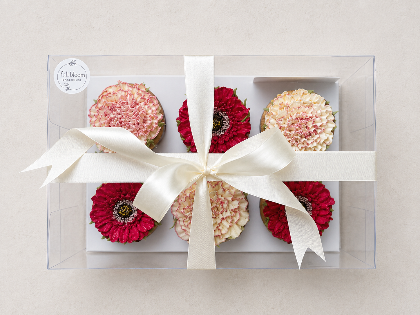 Hand-piped gerbera and carnation cupcakes decorated with realistic buttercream flowers, handcrafted in Dublin by Full Bloom Bakehouse. Elegant floral cupcakes perfect for gifting, celebrations and special occasions.