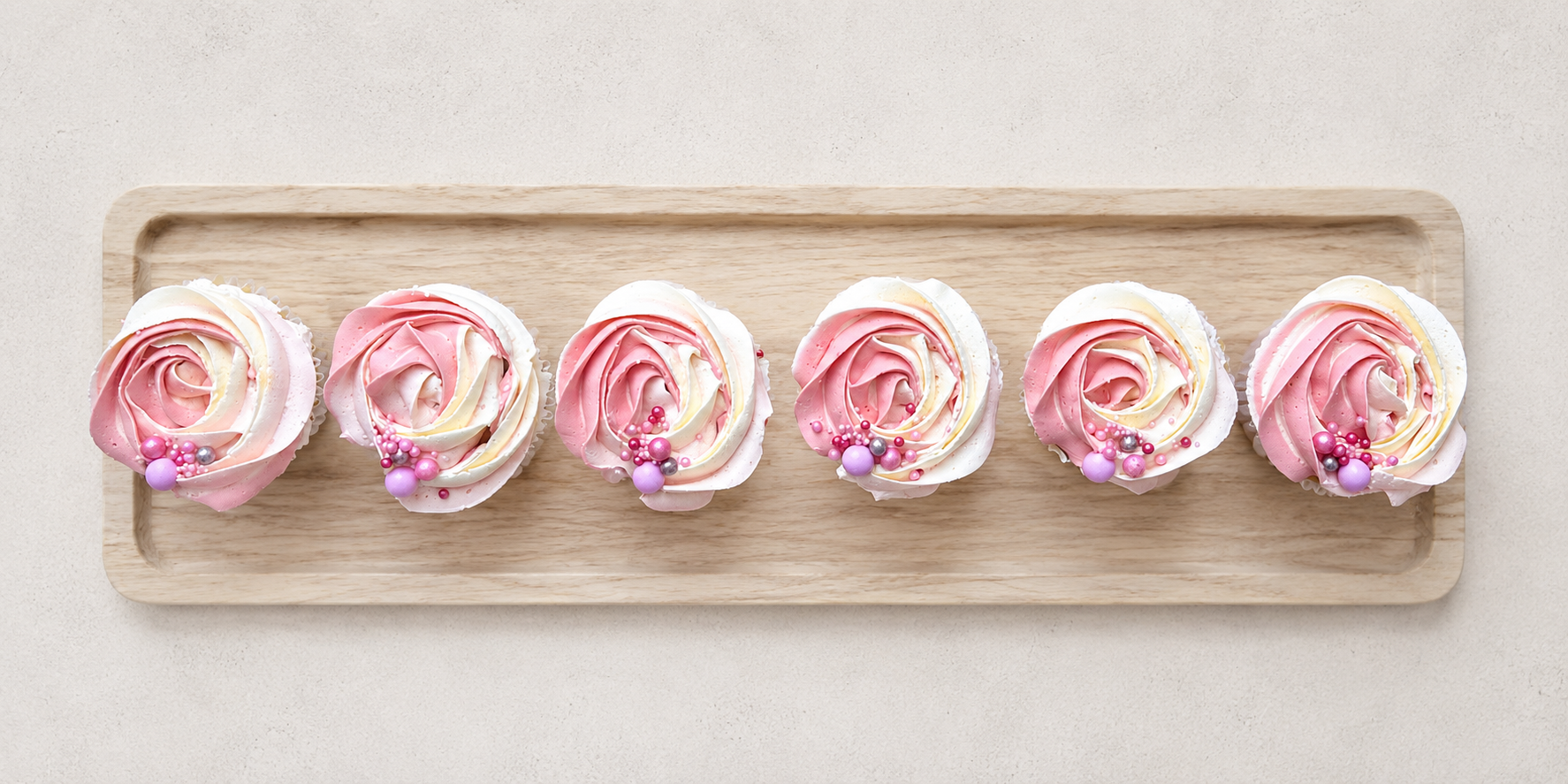Elegant swirl cupcakes decorated with light cream and blush pink buttercream rosettes, handcrafted in Dublin by Full Bloom Bakehouse. Delicate and timeless cupcakes perfect for weddings, engagements, baby showers, birthdays, Mother’s Day and elegant 