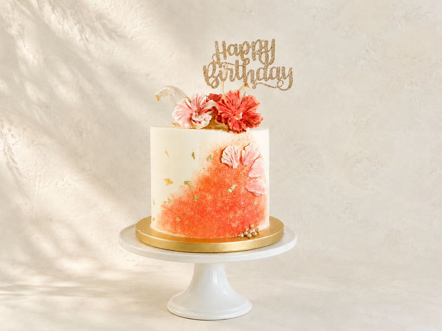 Tropical Velvet Floral Cake | Custom Birthday Cake in Dublin

Inspired by tropical elegance, this handcrafted buttercream cake features a delicate hand-piped hibiscus flower, edible gold leaf and shimmering isomalt sails for a modern, luxurious finis