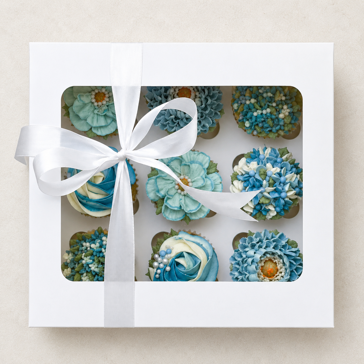 Hand-piped blue gerbera cupcakes with delicate white and blue blossom flowers, handcrafted in Dublin by Full Bloom Bakehouse. A beautiful floral cupcake collection for baby showers, gender reveal celebrations and welcoming a baby boy.