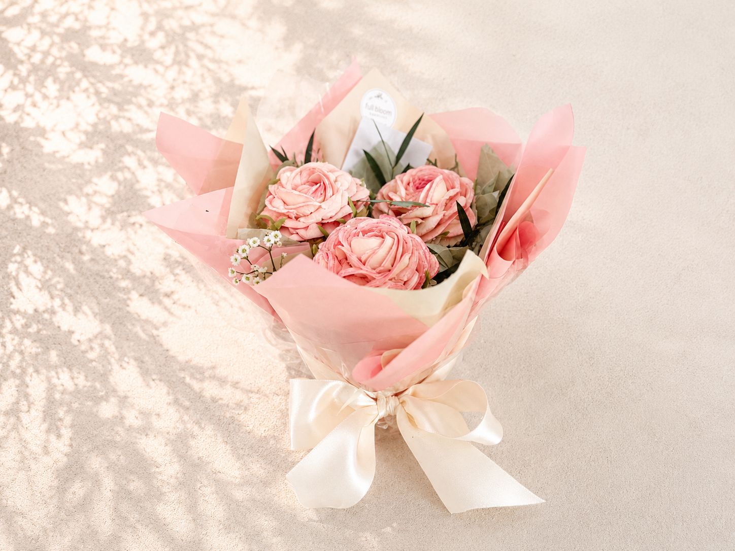 Three-cupcake rose bouquet featuring hand-piped pink buttercream roses, beautifully wrapped in pink paper and handcrafted in Dublin by Full Bloom Bakehouse. A luxury edible gift and elegant alternative to fresh flowers, perfect for birthdays, Mother’