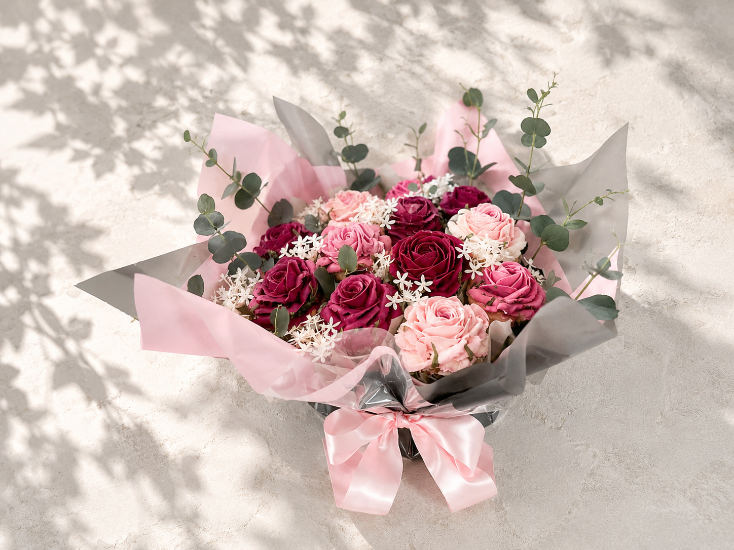 Hand-piped blush pink and deep pink rose cupcake bouquet with fresh eucalyptus, handcrafted in Dublin by Full Bloom Bakehouse. A luxury floral cupcake bouquet and elegant alternative to fresh flowers, perfect for birthdays, anniversaries, Mother’s Da