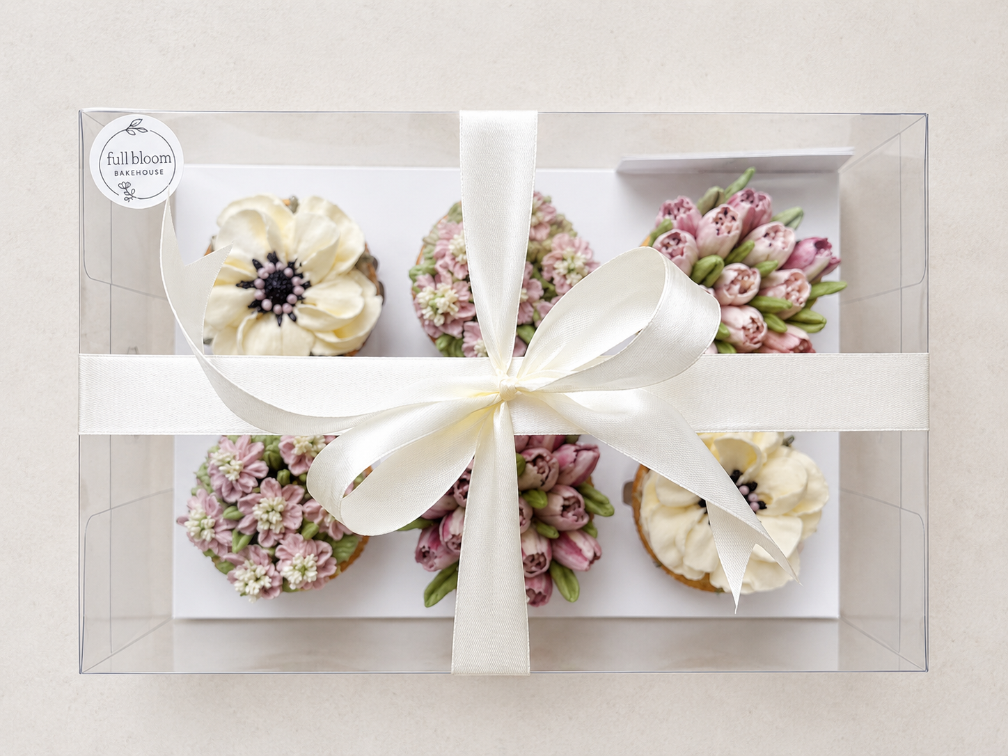 Hand-piped white poppy and tulip cupcakes featuring delicate buttercream flowers, handcrafted in Dublin by Full Bloom Bakehouse. Elegant floral cupcakes in soft ivory tones, perfect for gifts, weddings and special occasions.
