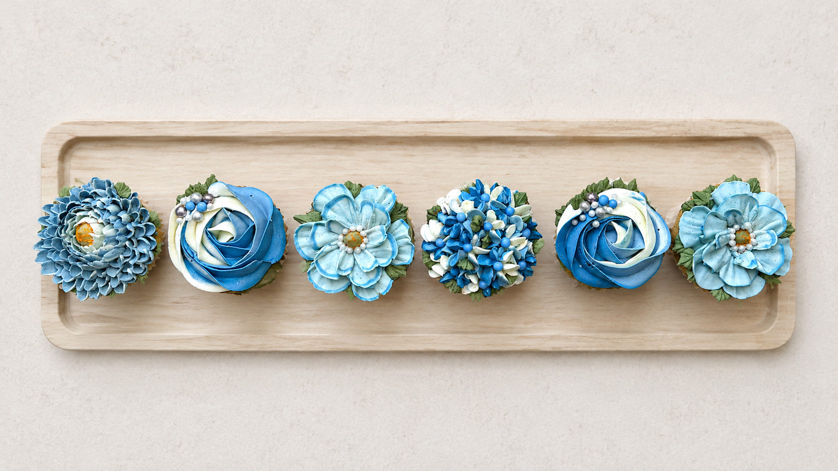 Mixed floral and swirl cupcakes in elegant blue and white tones, handcrafted in Dublin by Full Bloom Bakehouse. Featuring buttercream flowers and classic swirl cupcakes, this luxury collection is perfect for baby showers, gender reveal parties, birth