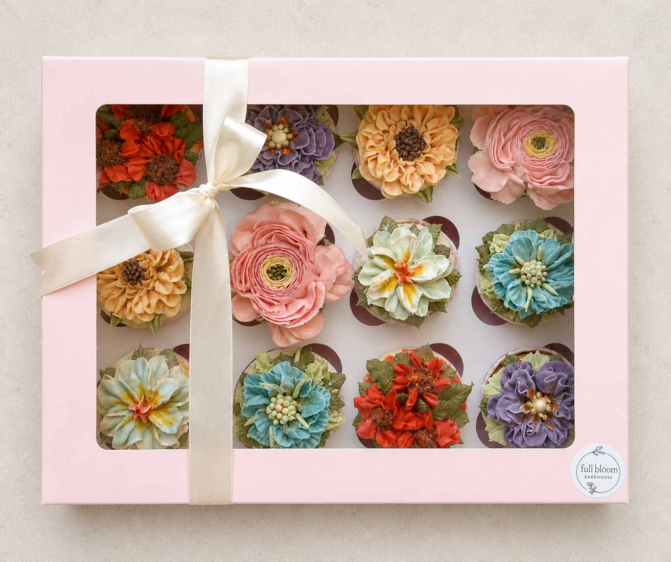 Hand-piped pastel floral cupcakes featuring pink roses and delicate buttercream flowers, handcrafted in Dublin by Full Bloom Bakehouse. Perfect for a baby girl celebration, girl's birthday party, spring gatherings and thoughtful summer gifts. Luxury 