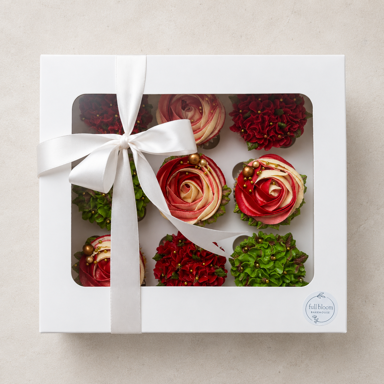 Hand-piped white and blush pink rosette cupcakes paired with green hydrangea-style buttercream flowers and finished with elegant gold sugar pearls. Handcrafted in Dublin by Full Bloom Bakehouse, these luxury floral cupcakes are perfect for birthdays,