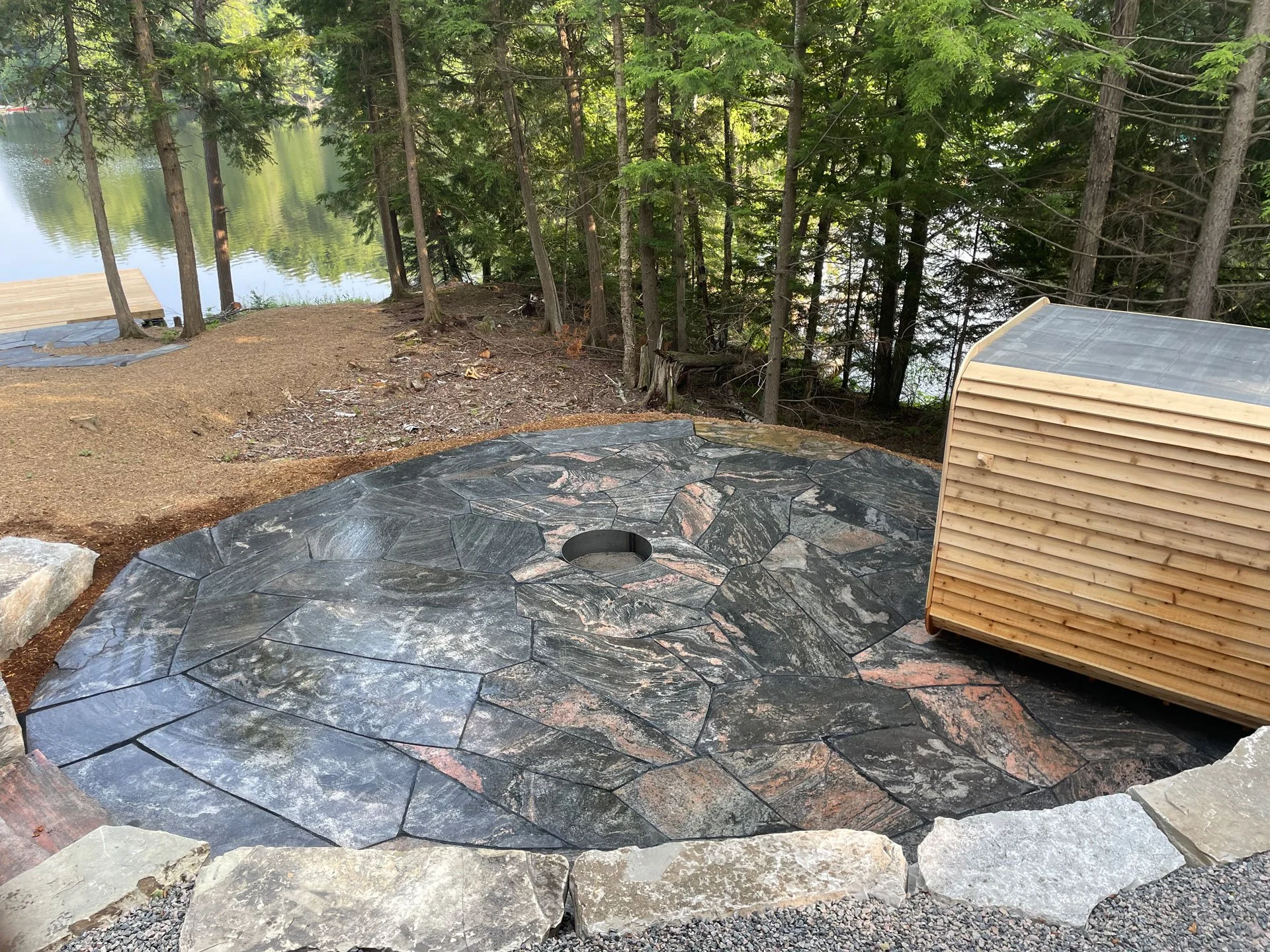 A granite patio with integrated firepit