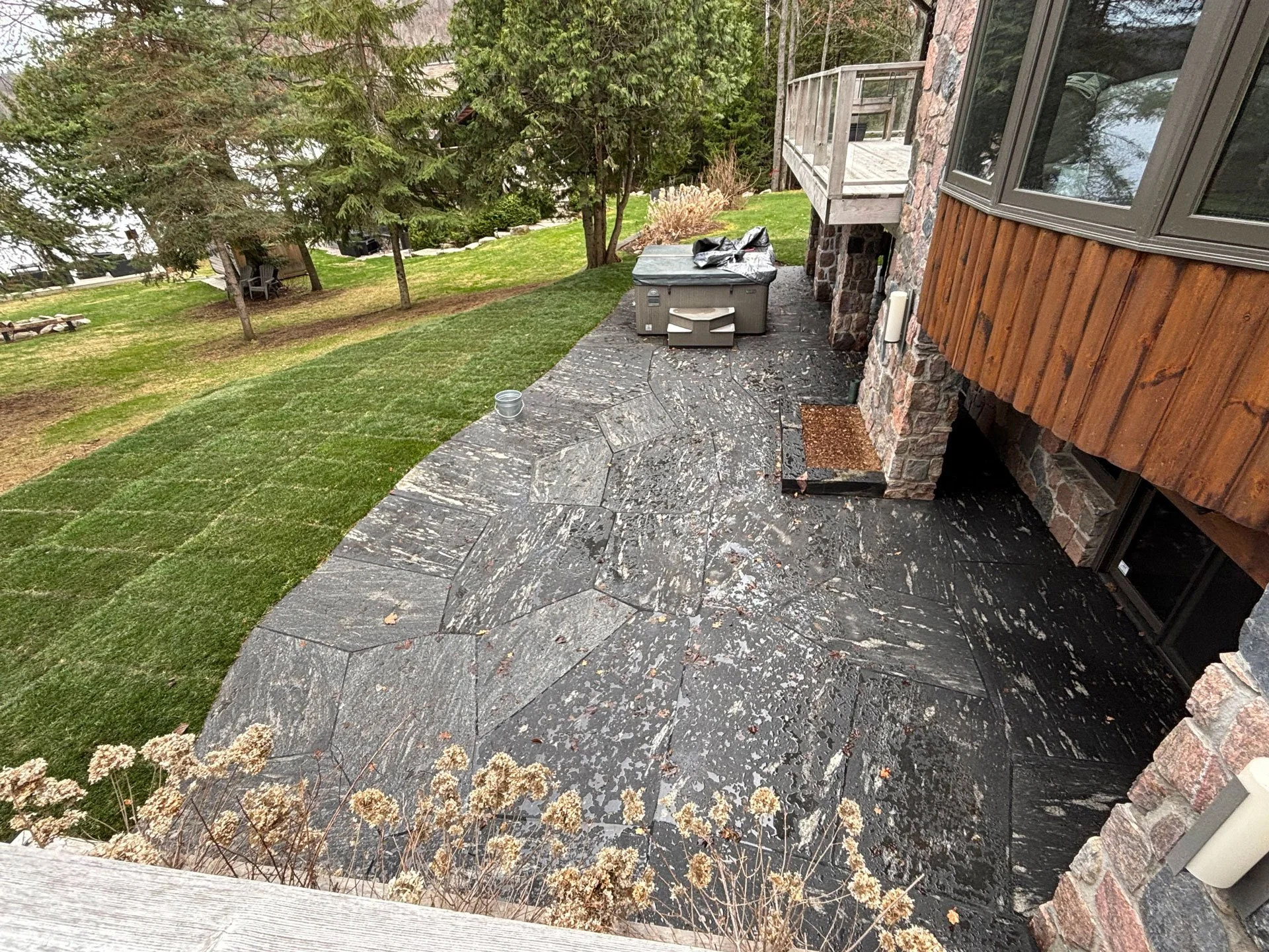 Back granite patio with planter and hot tub