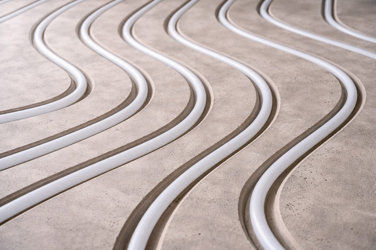 Curved white and brown lines embedded in a concrete surface.