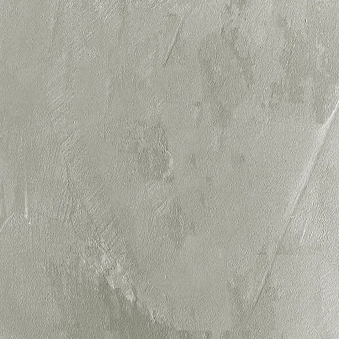 Close-up of a textured, light-colored wall with visible patches and scratches.