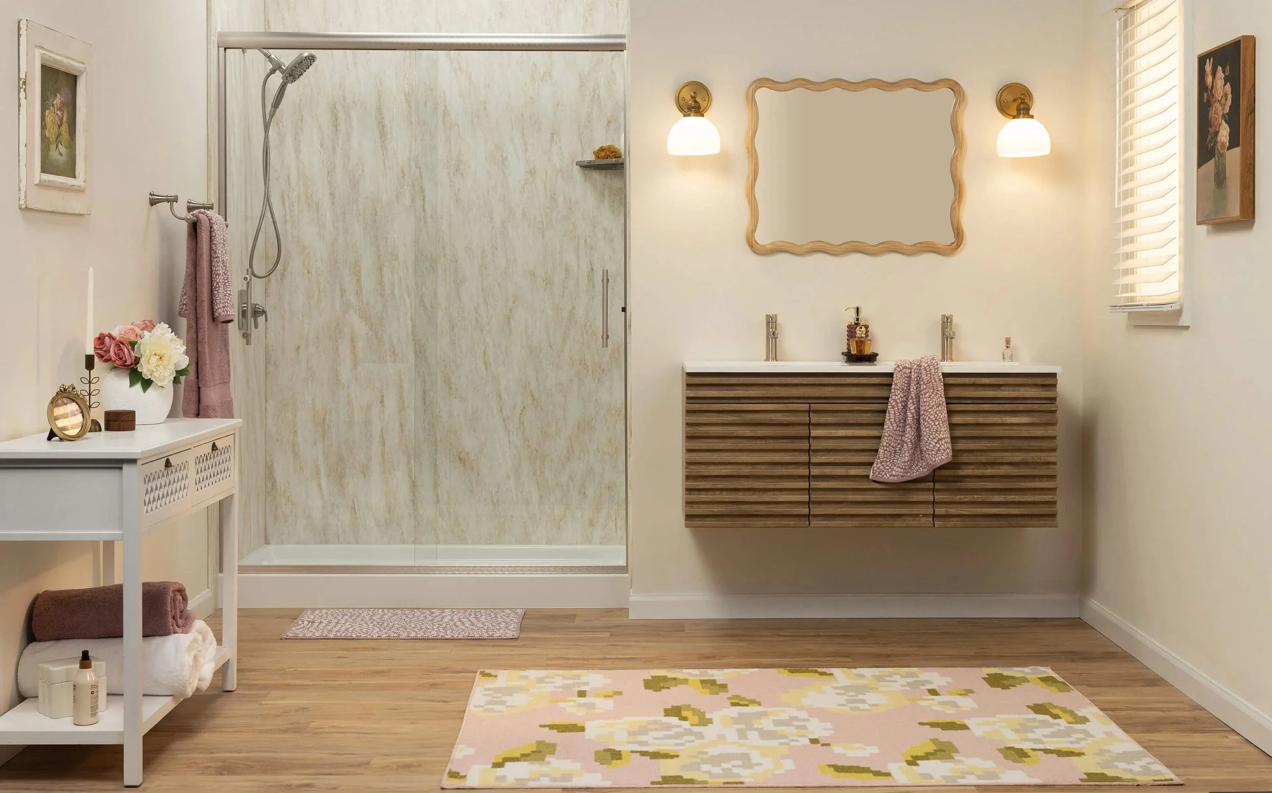 A bathroom with a walk-in shower, double sink vanity, and decor in soft pastel and wood tones.