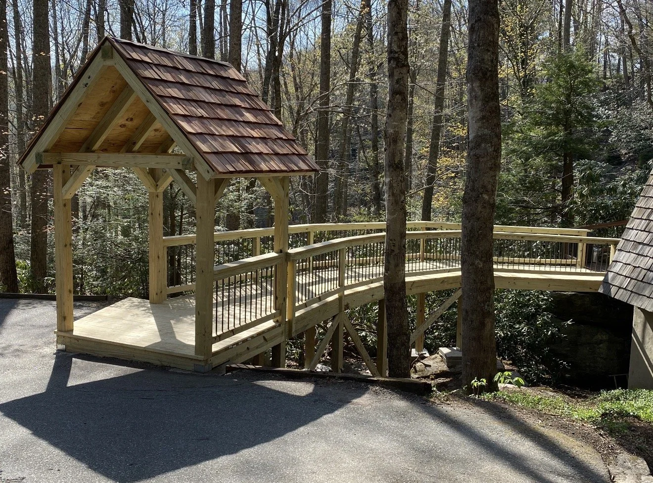 Newly constructed wooden bridge with a small covered lookout by Antonio's Construction serving Ashe and Watauga County in North Carolina.