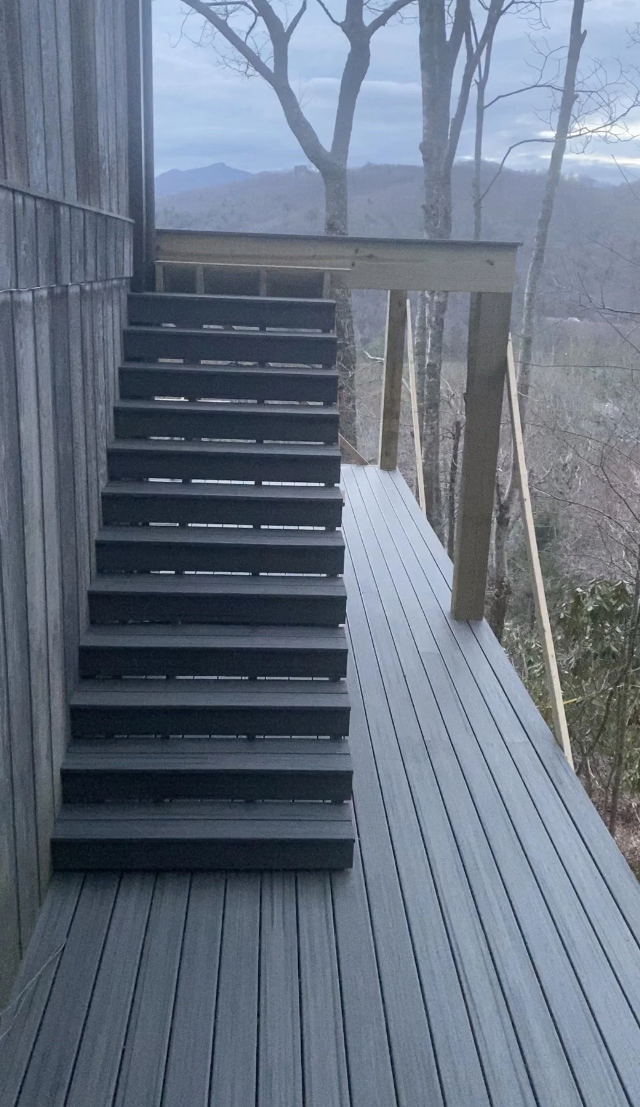 Newly built wooden deck with stairs by Antonio's Construction serving Ashe and Watauga County in North Carolina.