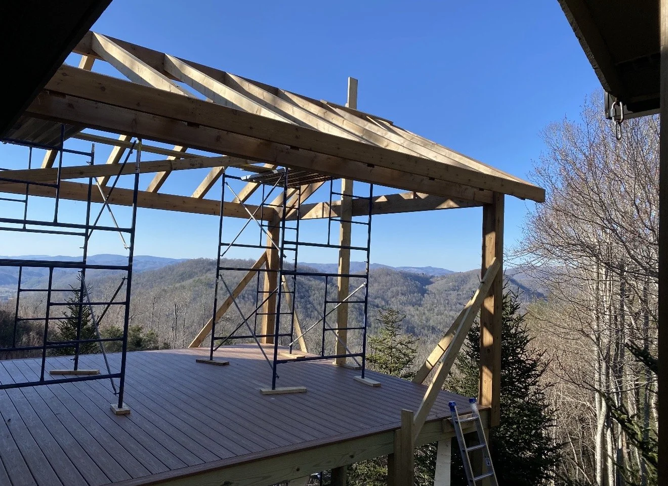 Construction site on a wooden deck with scaffolding by Antonio's Construction serving Ashe and Watauga County in North Carolina.