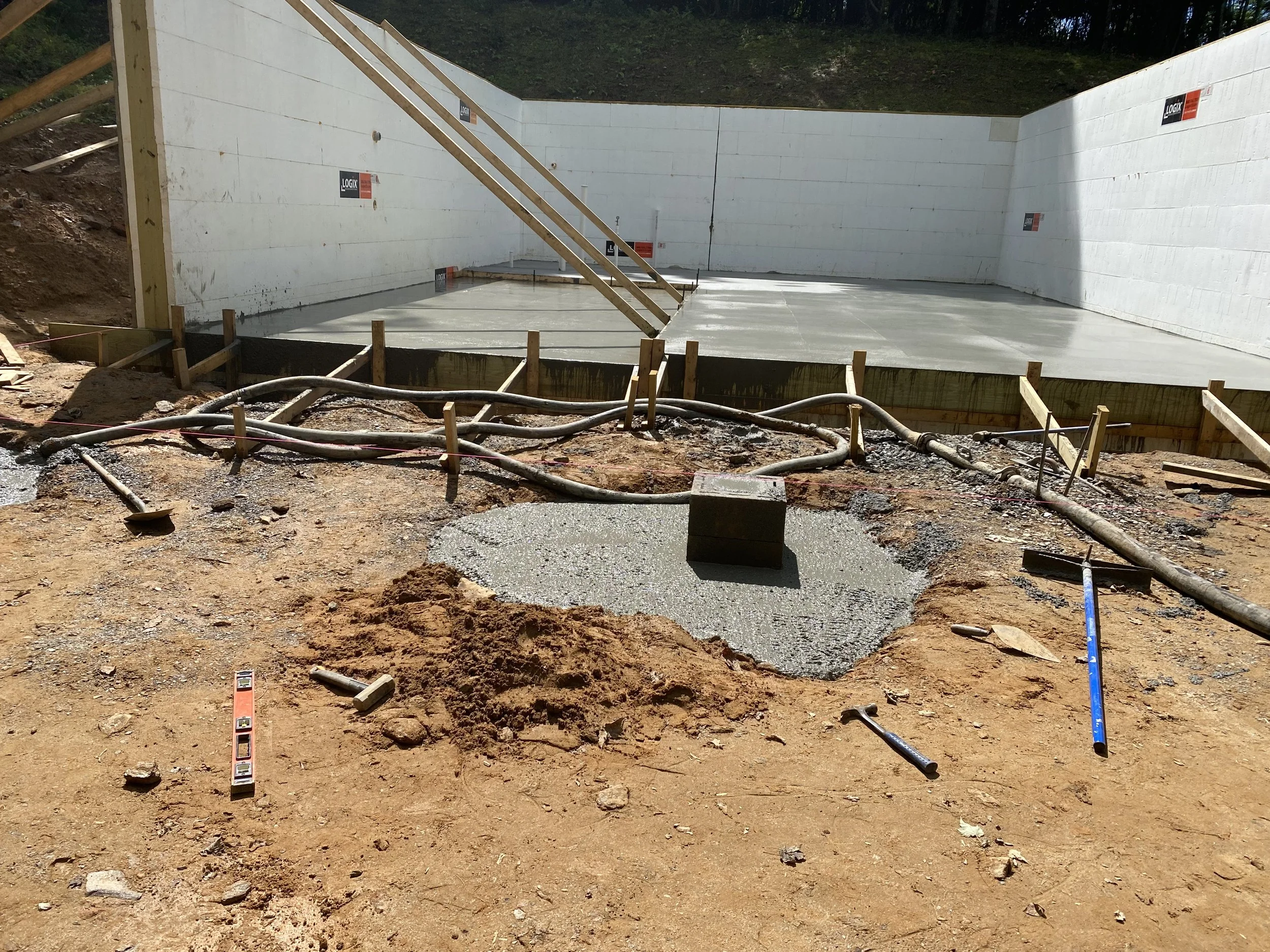 Construction site with concrete foundation walls and plumbing pipes by Antonio’s Construction providing exterior construction in Ashe County and Watauga County, NC
